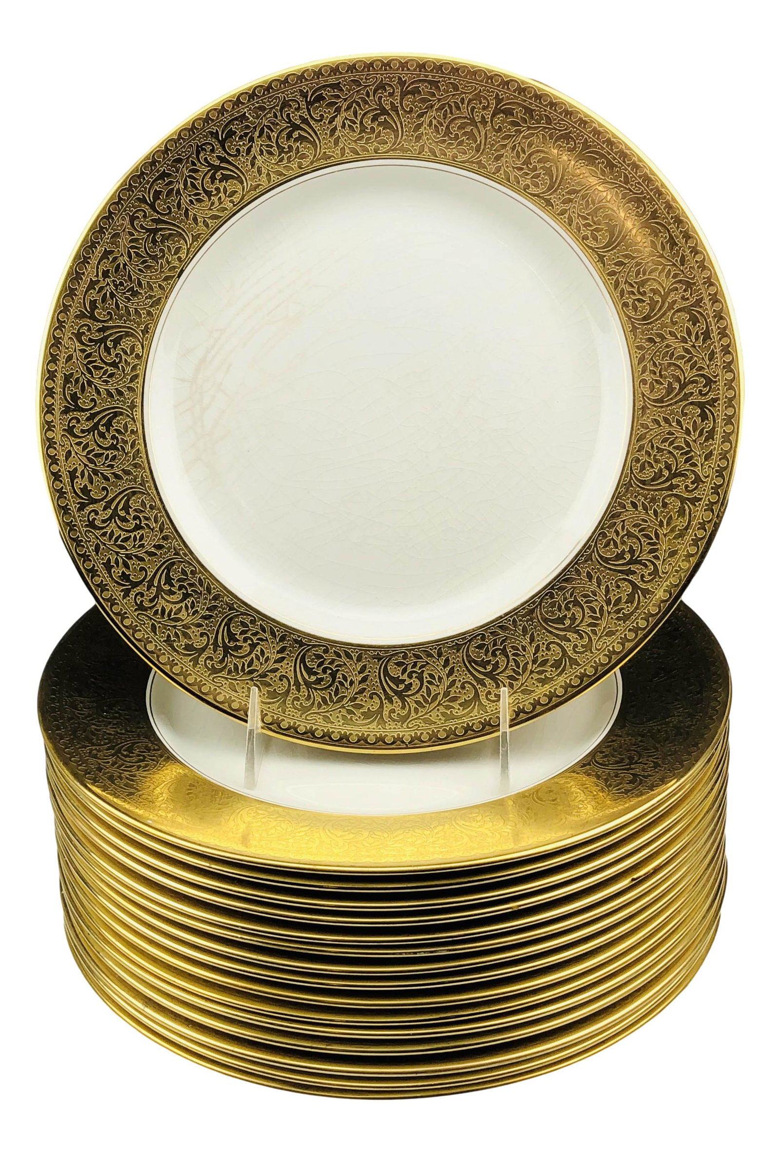 16 Johnson Brothers Pareek Gold Dinner Plates: Set of sixteen Johnson Brothers England pareek china dinner plates. Features a gold motif border with a white center. Marked on bottom. Dimensions: .5 X 10.5 X 10.5 in. Condition: Fair overall co