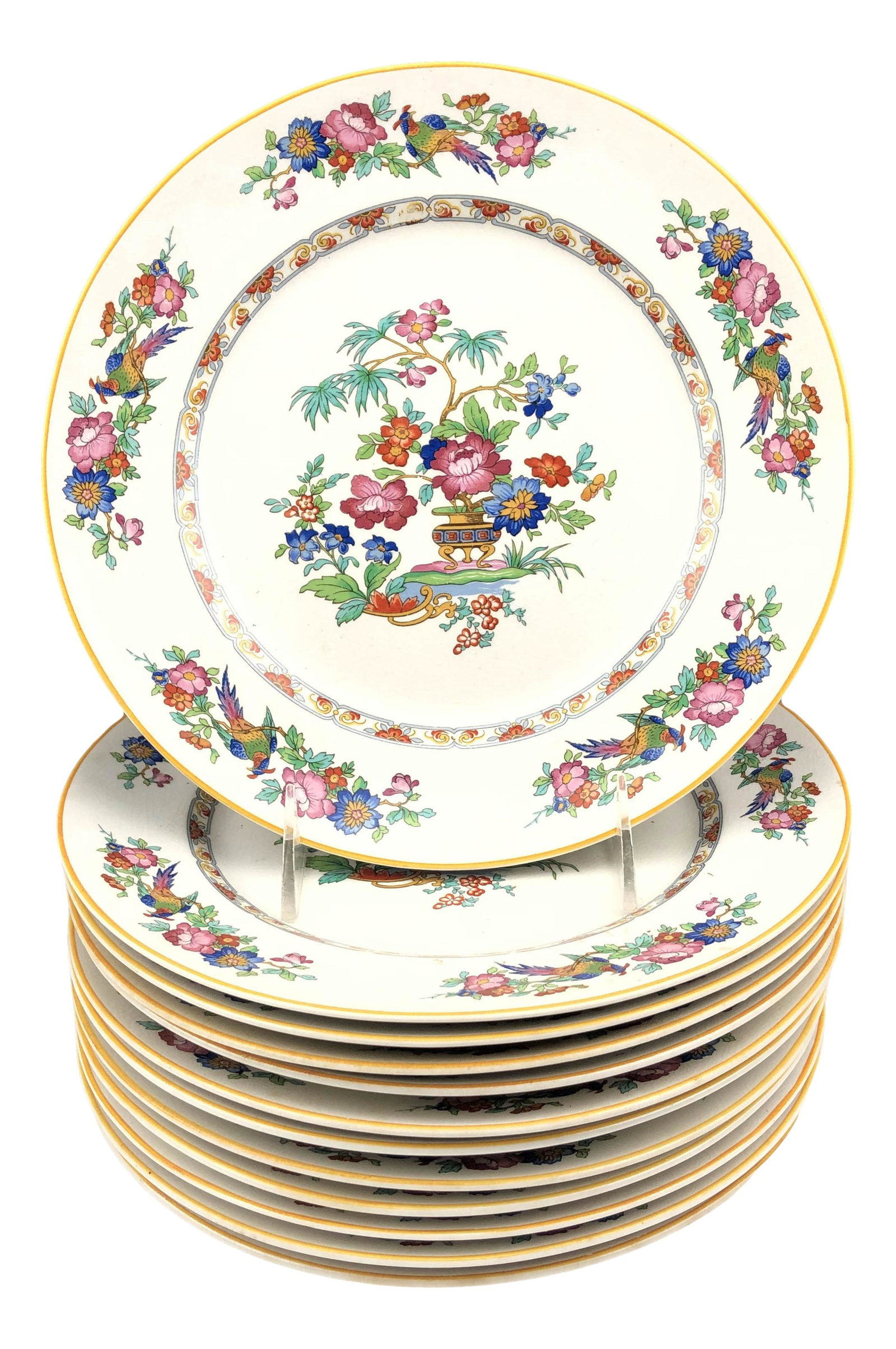 12 JE Caldwell & Co Floral China Salad Plates: Set of twelve JE Caldwell & Co salad plates. Features a flower pot in the center with a floral and pheasant design around the rim. Marked on verso. Dimensions: 1 X 9 X 9 in. Condition: Good overa