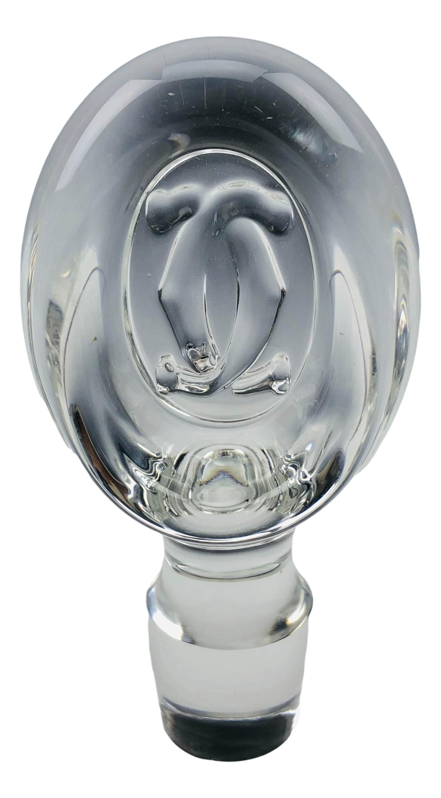 Cartier Crystal Bar Barware Wine Decanter Stopper: Oval shaped clear crystal glass stopper with dauber. Interlocked letters C in raised relief featured on opposite sides. Measures 4 1/4" x 2". No other apparent markings. Condition: Good overall condit
