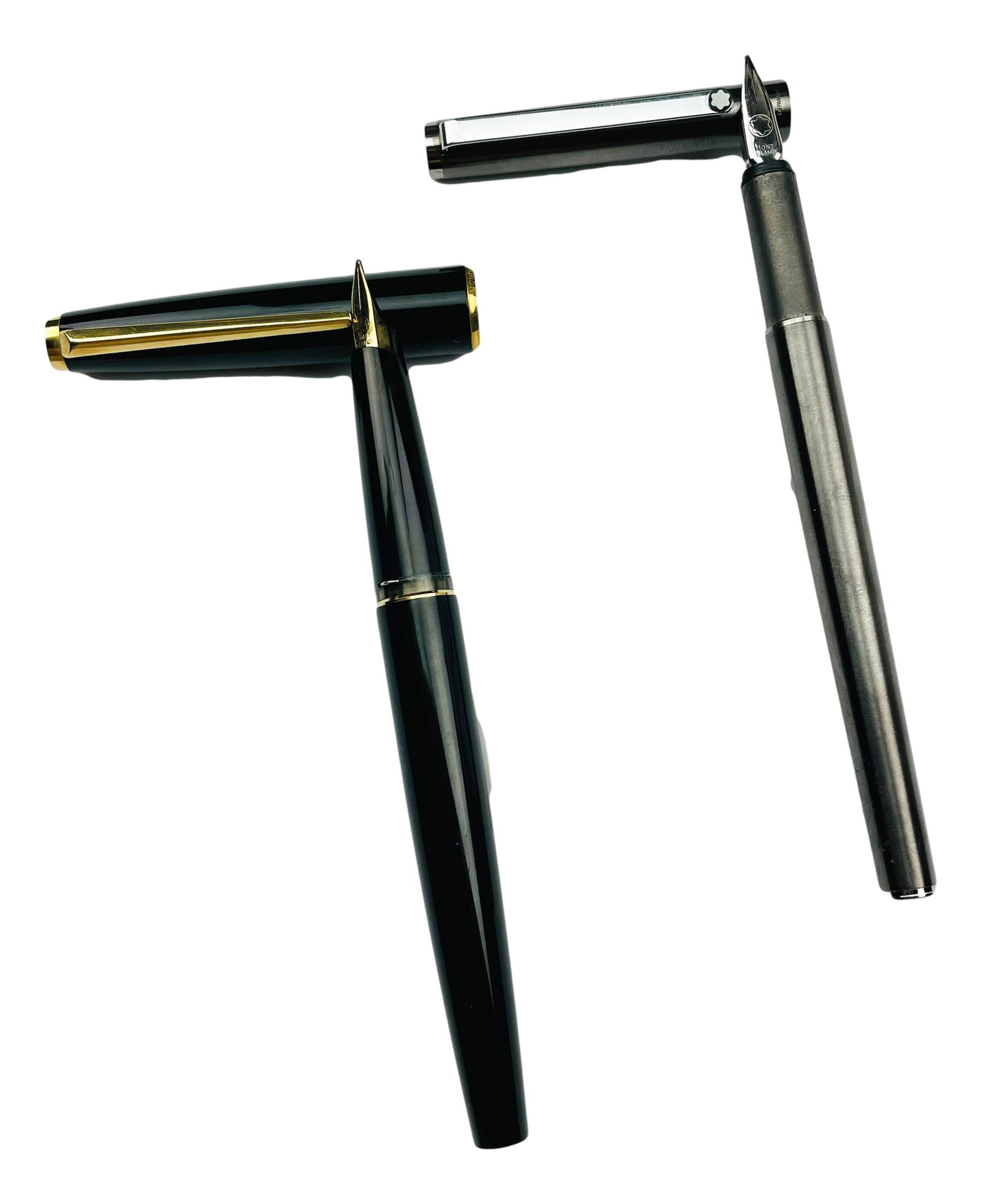 Montblanc Germany Fountain Writing Desk Pen Lot 2: One pen graced with a black cap and barrel, gold toned furnishings with gold color / gold tone nib ( no markings ). The other is the Noblesse Slimline with gunmetal steel cap and barrel and stainless 