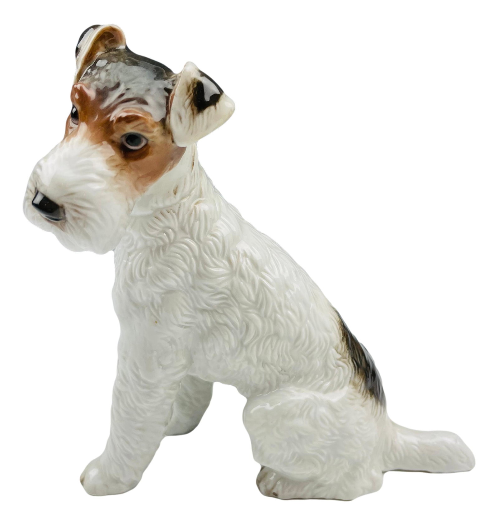 Rosenthal Fox Terrier Porcelain K9 Dog Figurine: Designed by Max Hermann Fritz ( German, 1849 - 1913 ). Artist and sculptor. Model number 1243. Status : Retired. Features this dog in seated pose, a puzzled look on his face. Measures 6" x 5 3/4". Sig