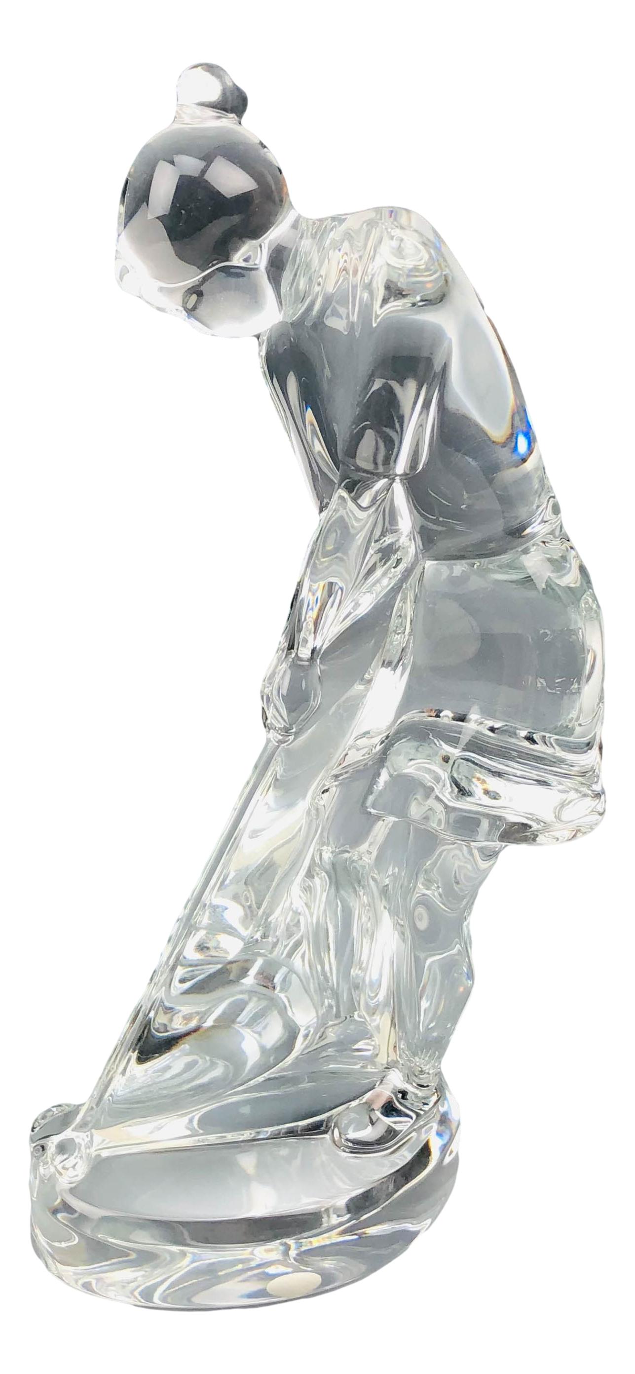 Baccarat Crystal Lady Golfer Art Glass Sculpture: Features a lady golfer setting up for a put. Sparkling crystal clear clarity as would be expected of Baccarat. Measures 9" x 4 1/2". Signed with the Baccarat script name on the base. Underside with th