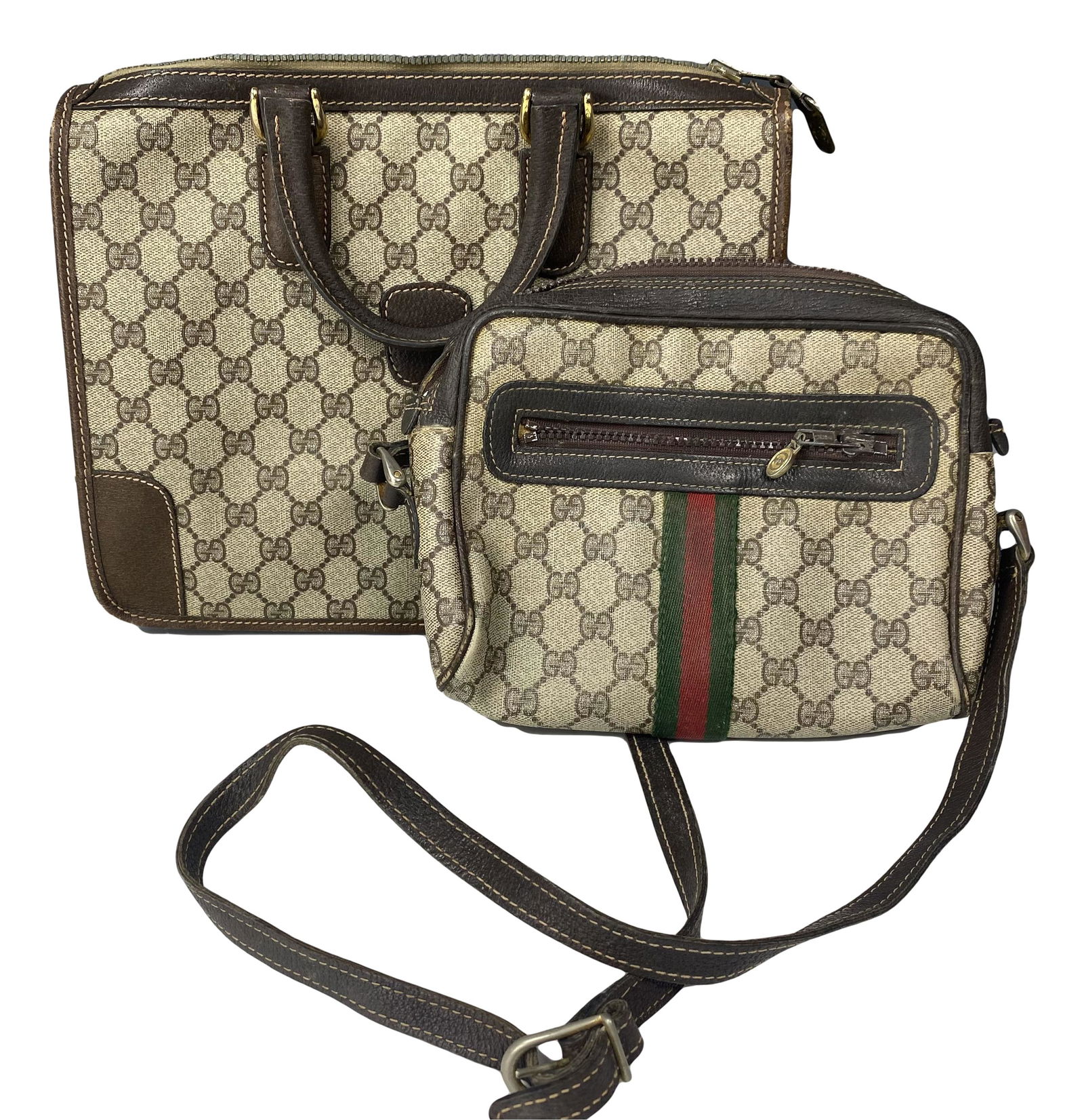 Gucci Designer Italian Monogrammed Handbag Purses: Two Italian Vintage Gucci purses. Composed of brown canvas and leather with the GG monogram logo all over. Includes (1) double handled bag measuring 14 in x 12 in x 1 1/2 in; and (1) 17" shoulder stra
