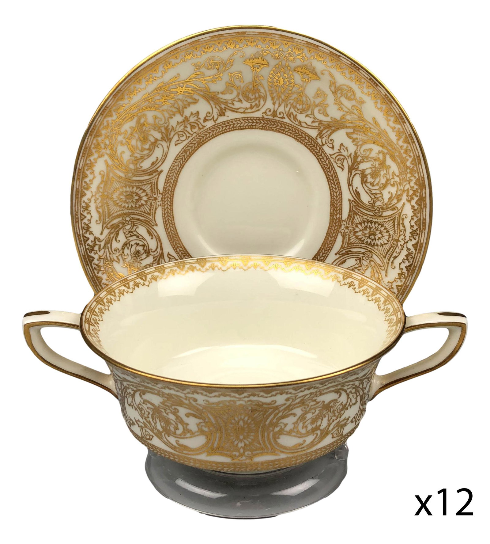 Royal Worcester Embassy Cream Soup w Saucer 24 pc: 20th century English bone china dinner plates modeled in the "Embassy" pattern by Royal Worcester. Each features raised relief ornate gold filigree decorations around the border against a cream ground