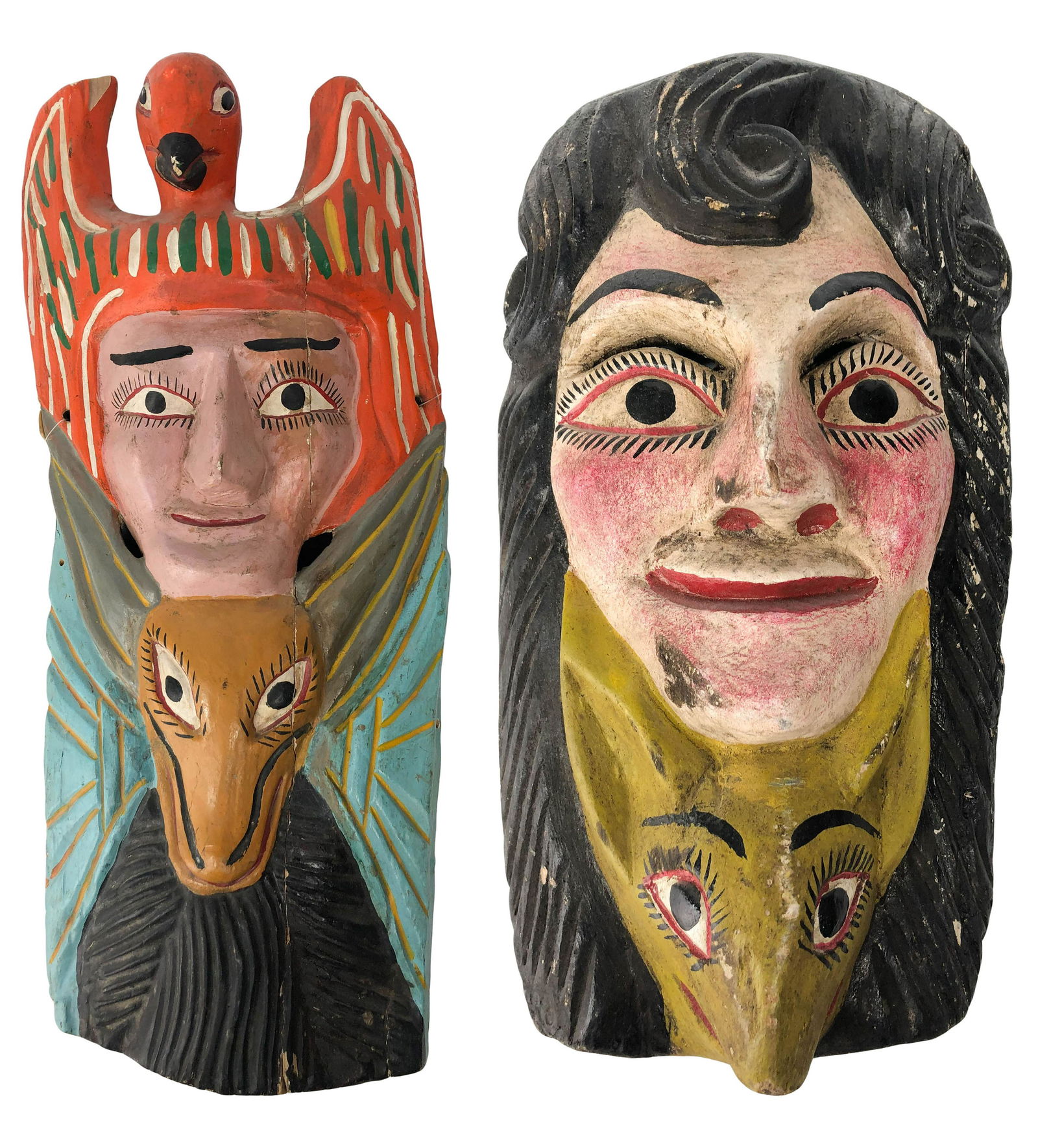 Mexican Hanging Wooden Folk Art Face Mask GROUP: Group of two Mexican face masks. Hand carved wooden hanging wall mask sculptures featuring a figural and animal image. Larger measures 23" x 10" x 6"; smaller measures 13" x 7" x 4". Condition: Good o