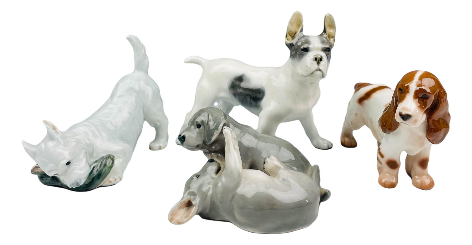 Copenhagen Bing Grondahl 4 Porcelain Dog Figurine: Include the following articles ~ 1 x Royal Copenhagen Pointer Puppies. #453. Designed by Erik Nielsen. 1 x Bing Grondahl Cocker Spaniel #2172. Designed by Sven Jespersen. 1 x Royal Copenhagen Bulldog 
