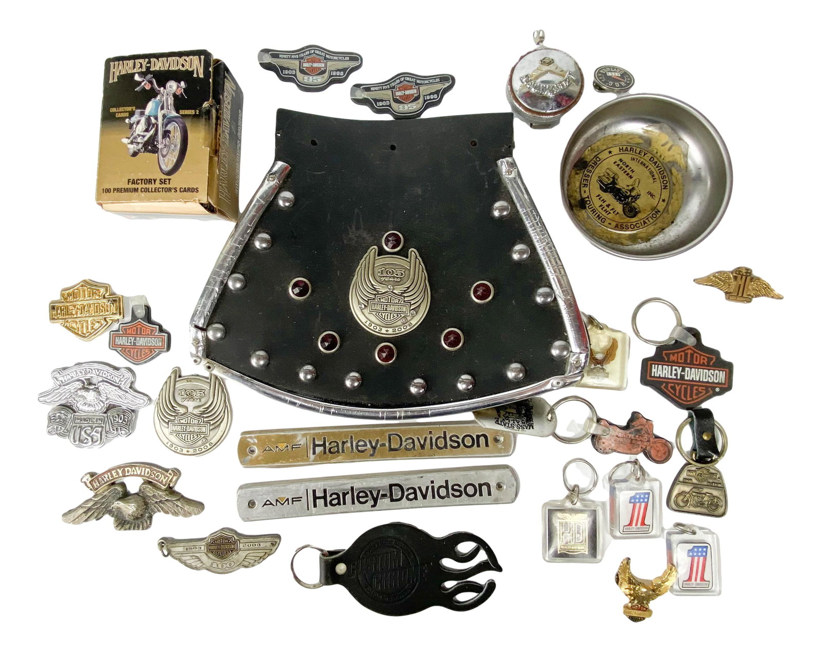 Lot Harley Davidson Motorcycle Collectibles & More: Includes and assortment of Harley Davidson related memorabilia including a tire mud flap, box of collector's cards, key chain, magnetized bowl and more. All with varying sizes and shapes. Signed ~ sta