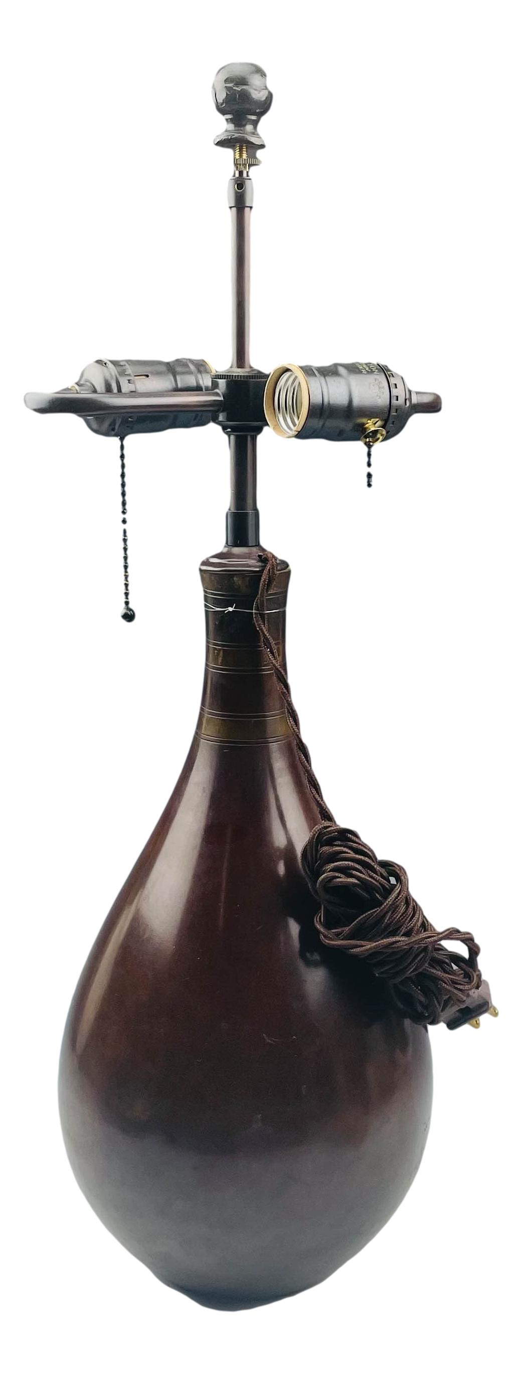 Just Andersen (1884-1943) Art Deco Bronze Lamp 22": Just Andersen ( Danish, 1884 - 1943 ). Of simple organic inspired form with a smooth high mirror polished finish. Measures 22" x 7 1/2". Signed ~ impressed Just Denmark B2053.Condition: Good overall c