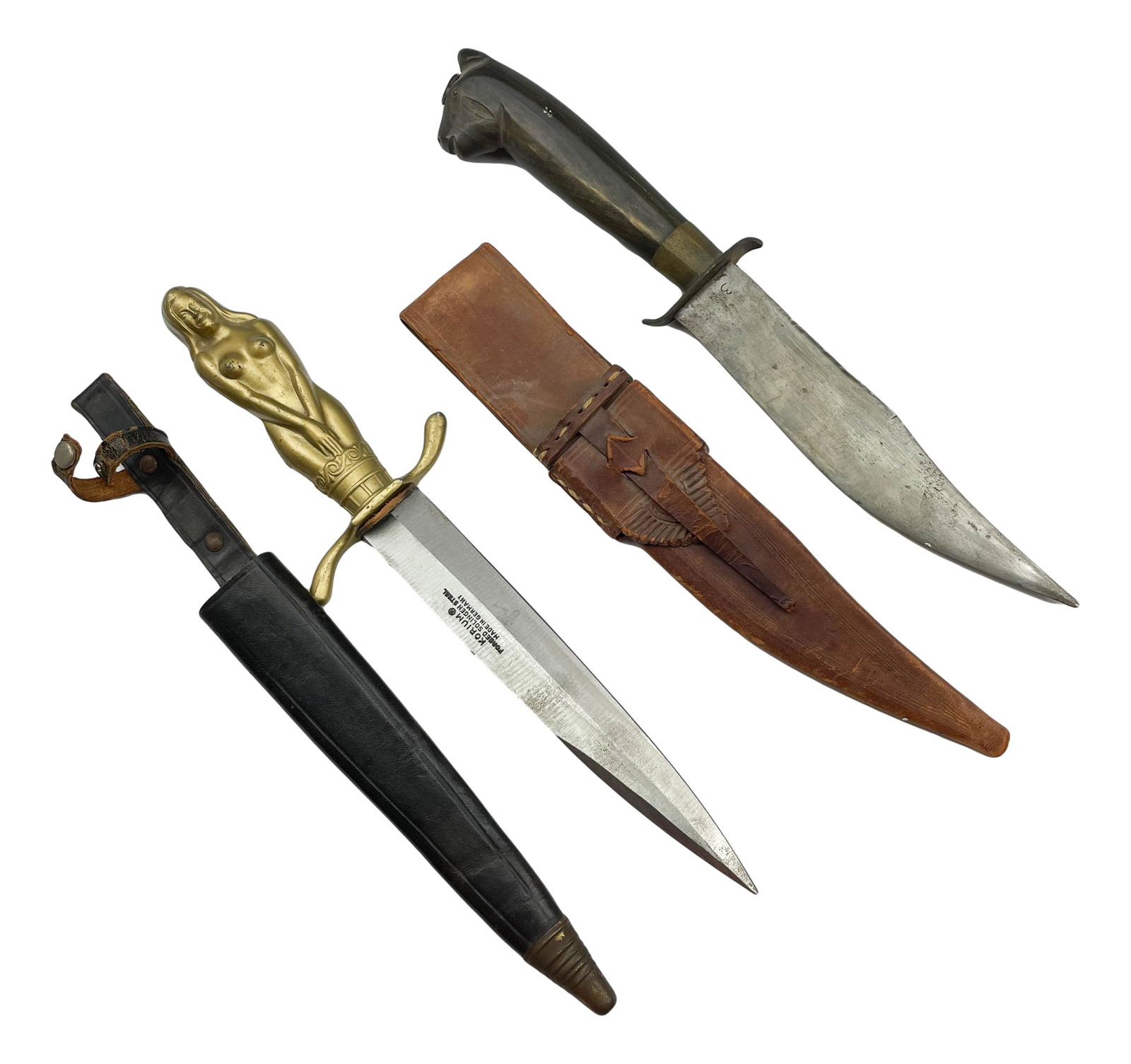 Korium & Batan Art Deco Style Dagger Knife Sheath: Includes the following articles. 1 x Korium German Forged Solingen Steel with a figural nude hilt. The other is stamped Batan 1945 on the blade with a carved wood horse head hilt. Both accompanied wit