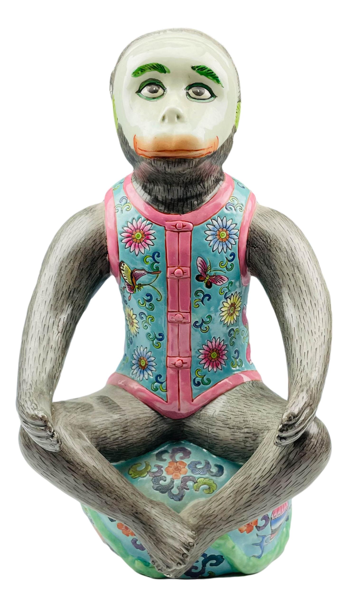 Chinese Ceramic Sitting Yoga Monkey 14" Figurine: Crafted out of ceramic. Features a monkey sitting in a yoga position hearing a floral and butterfly multi-colored vest. Dimensions: 14 X 8 X 8 in. Condition: Good condition having average wear. E