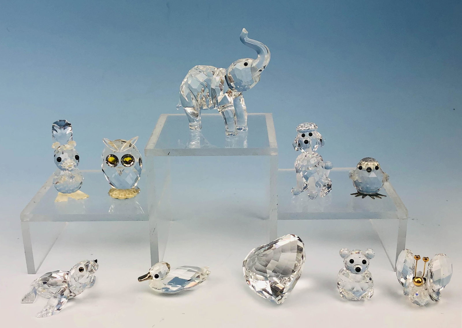 Swarovski Austrian Crystal 10pc Glass Figurine LOT: Includes ~ 1 x Clear Heart Paperweight. 1 x Mini Duck with Silver Beak. 1 x Elephant trunk up. 1 x Squirrel with Nut. 1 x Poodle. 1 x Mini Bear. 1 x Baby Seal. 1 x Mini Owl. 1 x Chick. 1 x Butterfly w