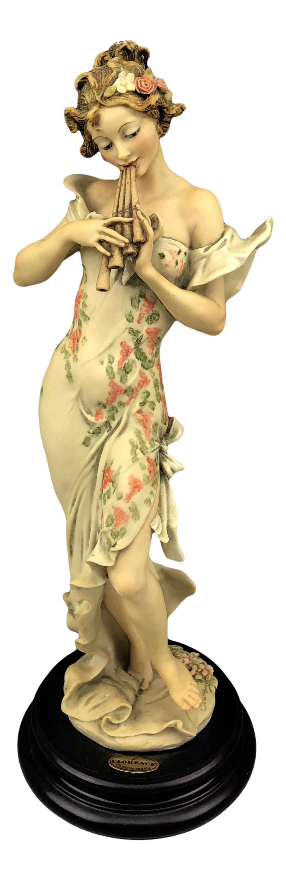 Armani Melody 656C Girl Playing Pan Flute Figurine: Giuseppe Armani ( Italian, 1935 - 2006 ). Celebrated and internationally respected artist / designer and sculptor. Titled Melody #656C. Depicts a tall slender woman playing the pan flute. Open Edition