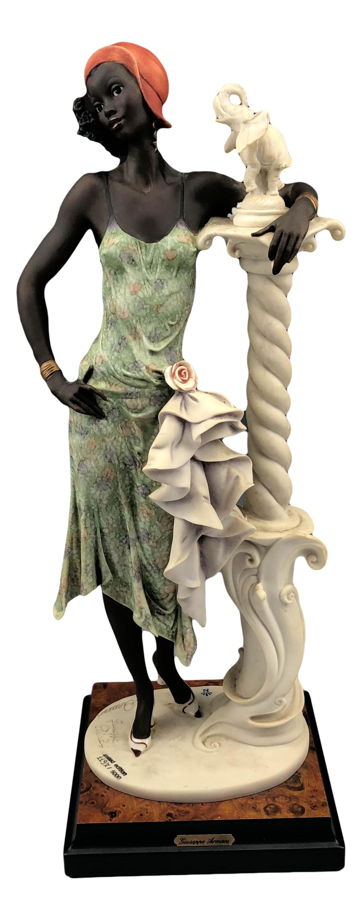 Armani Mahogany #194C Limited Edition LE Figurine: Giuseppe Armani ( Italian, 1935 - 2006 ). Celebrated and internationally respected artist / designer and sculptor. Depicts a slender black woman, one hand resting on a column with has an elephant stat