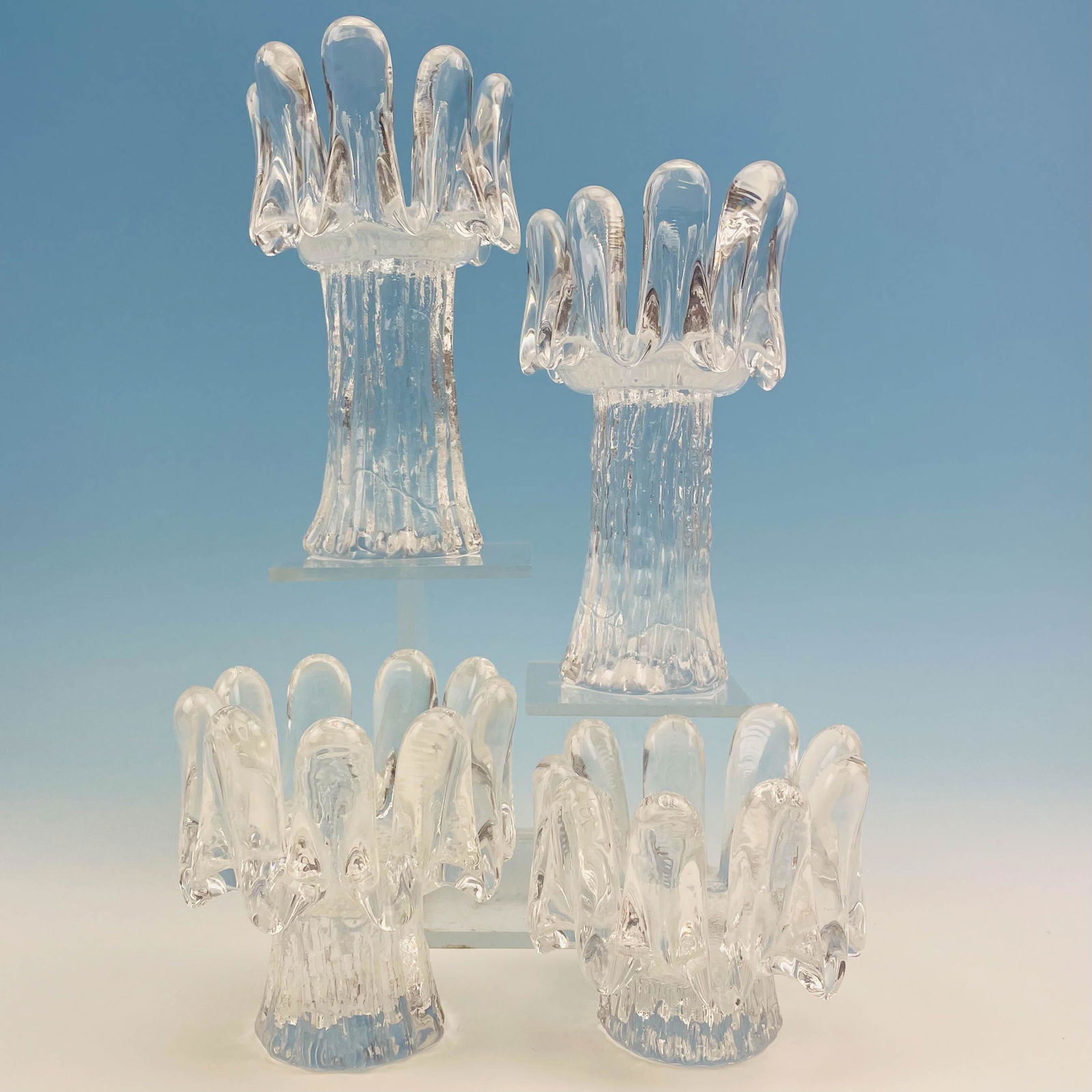 Goran Warff Kosta Sunflower Candle Holder 4pc LOT: Goran Warff Kosta Boda Sunflower Candle Holder four piece lot. Features (4) Sunflower shaped glass candle holders design by Goran Warff as part of the Sunflower collection in 1974. Largest measures 7.