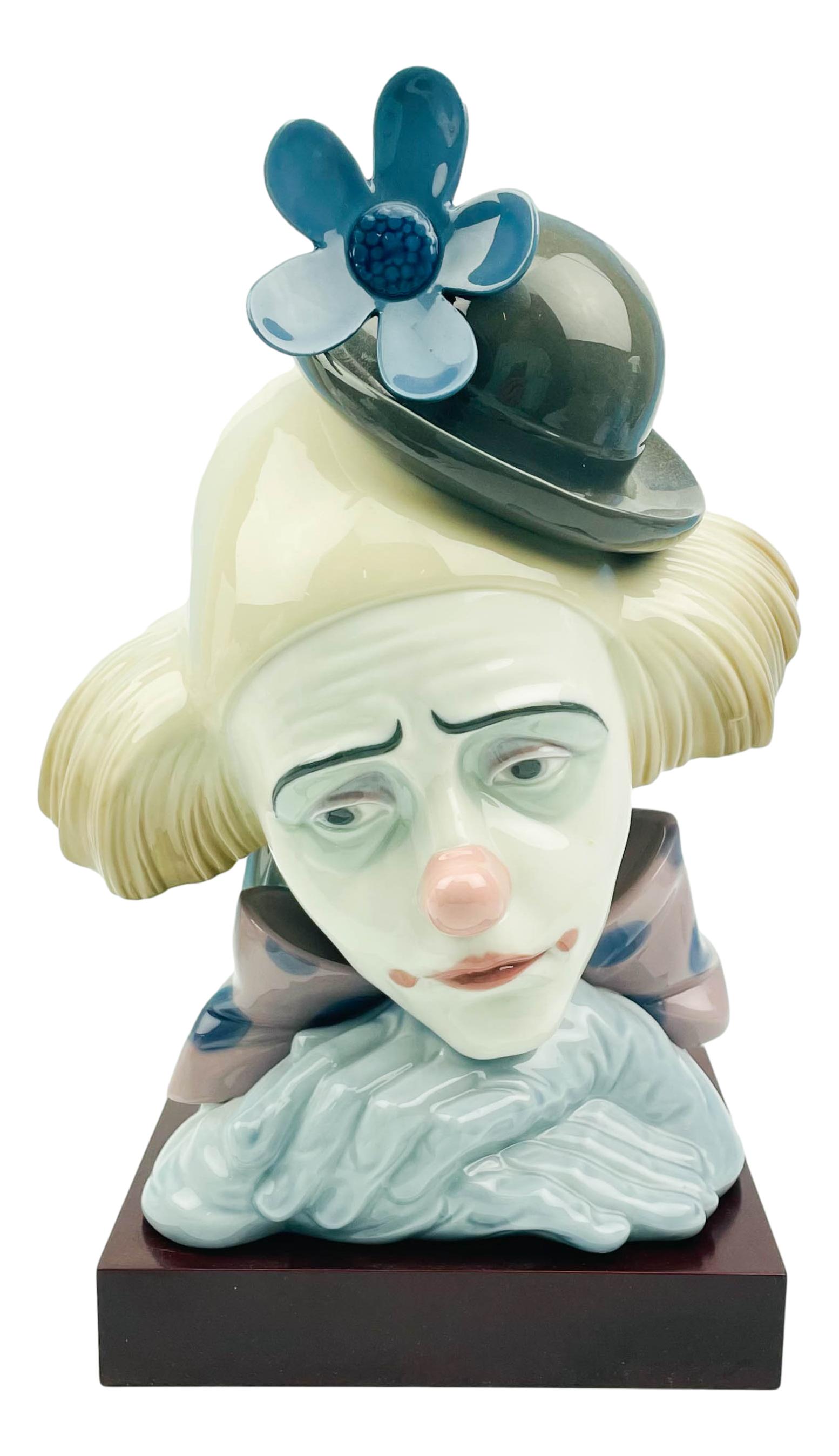 Lladro Spanish Porcelain CLOWNS HEAD Sculpture: A Lladro Spanish porcelain figural bust statue. Titled, "Clown's Head Bowler Hat," model number 5130, produced circa 1982, designed by artist Jose Puche. LLADRO backstamp to underside. Dimensions: 10.