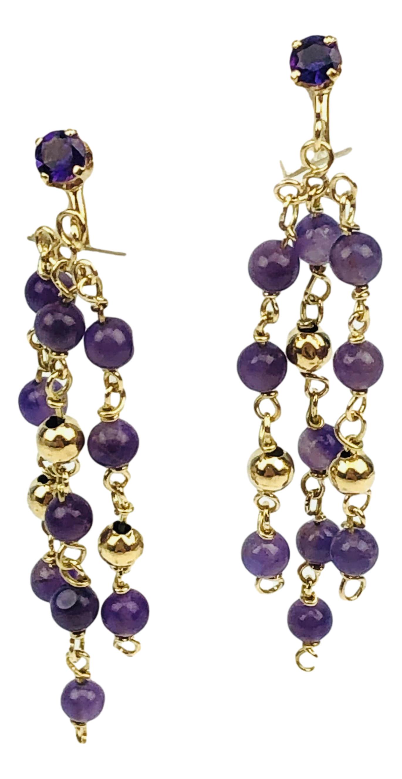 14K Gold Pair Amethyst Dangle Chandelier Earrings: Pair of dangle chandelier women's earrings crafted of 14K yellow gold and graced with amethyst gemstones and beads. Measure 2 3/8". No apparent markings. Tests/ Tested positive for 14K. Total combined