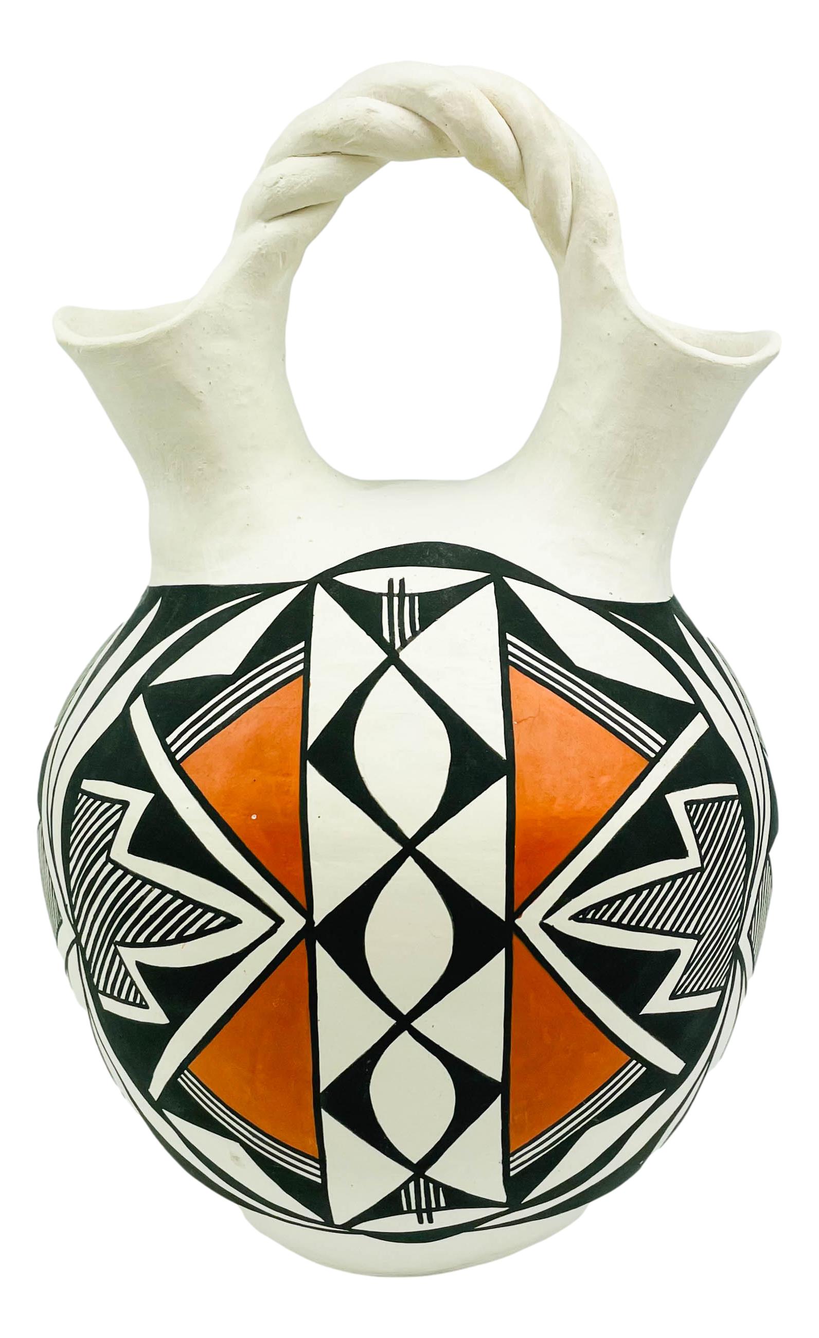 Hilda Antonio American Indian Pottery Wedding Vase: Designer / Artist / Potter Hilda Antonio ( New Mexico, born 1938), Part of the Acoma Pueblo Roadrunner Clan. Features a polychrome decorated wedding vase with black, white and brick red geometric Unde