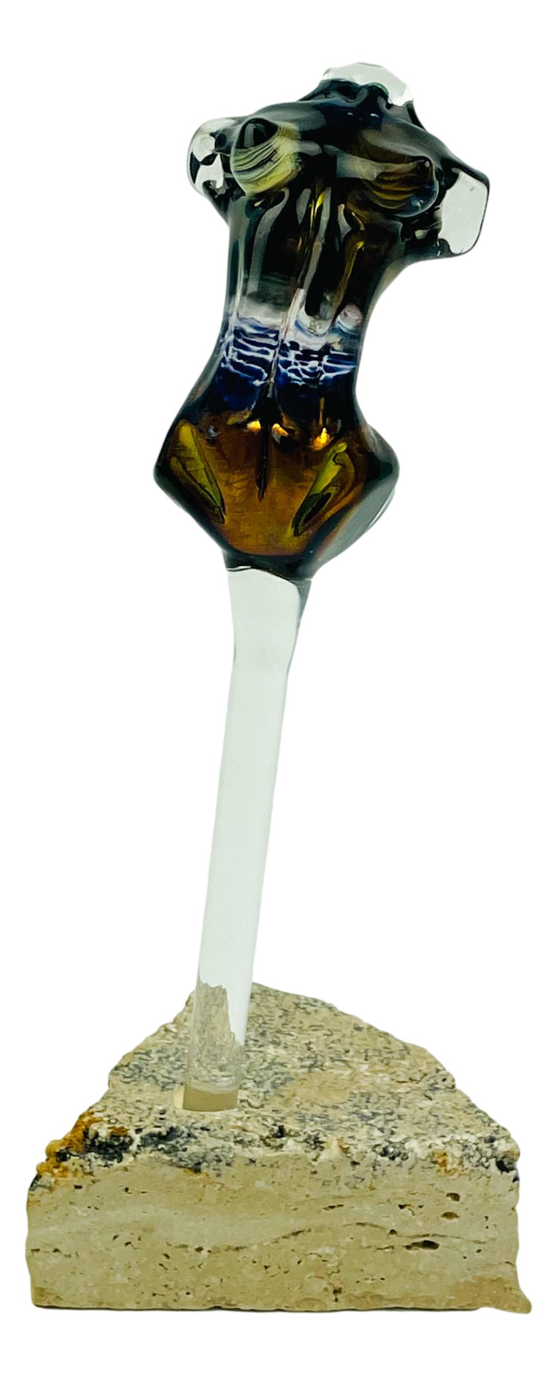 Mystery Maker Studio Glass Nude Torso Sculpture: Subject matter depicts a studio hand blown cased multi colored and gold iridescent nude woman torso with a long clear glass dauber wand that fits into triangular shaped concrete stone base. No apparen