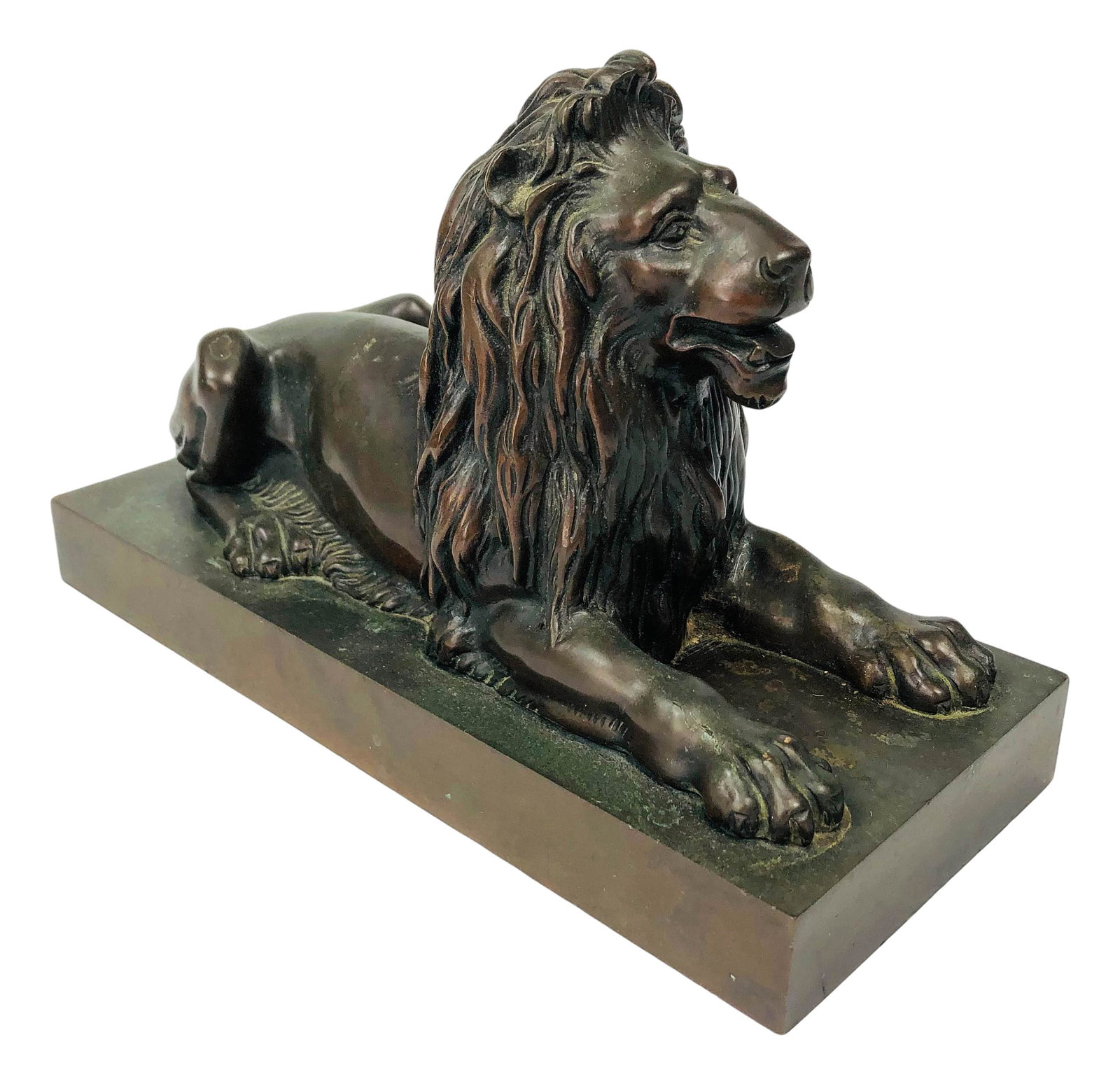 Antique Bronze Art Deco Seated Lion Sculpture: Modeled with a strongly influenced Art Deco style. Depicts the Lord of the Jungle in reclining / seated pose. Mounted on a rectangular base. Well detailed in manner and retaining its patina. No appare
