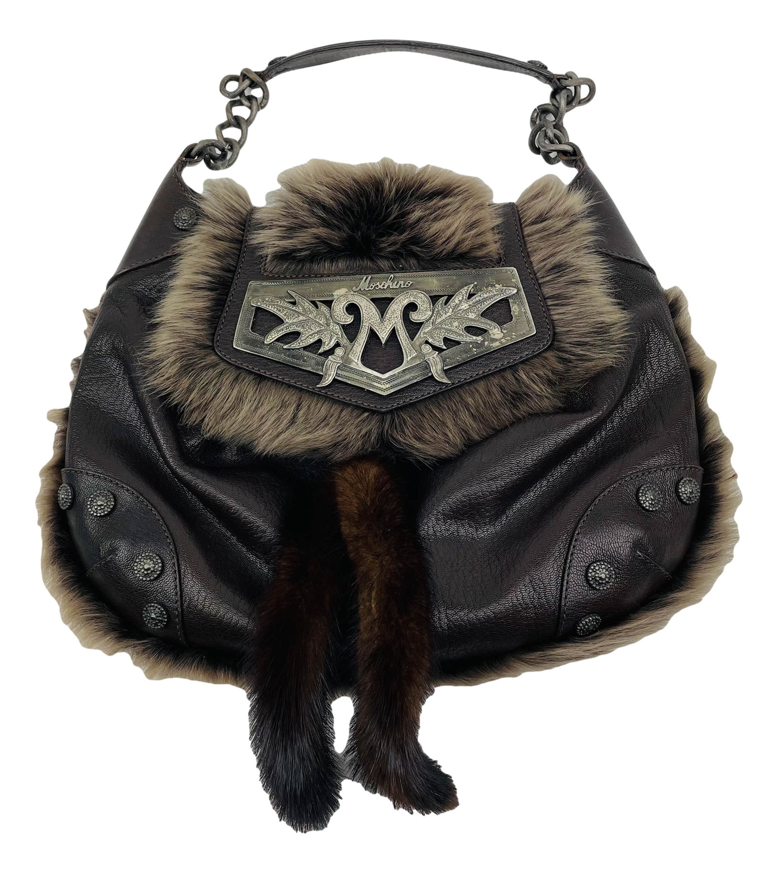 Moschino Vintage Leather Fur and Metal Handbag: Moschino Italian fashion house handbag. Bag is vintage 1980s. Brown leather body. Embellished with metal circles. Flap has metal plate flanked with leaves and M and Moschino incorporated. Leather whip
