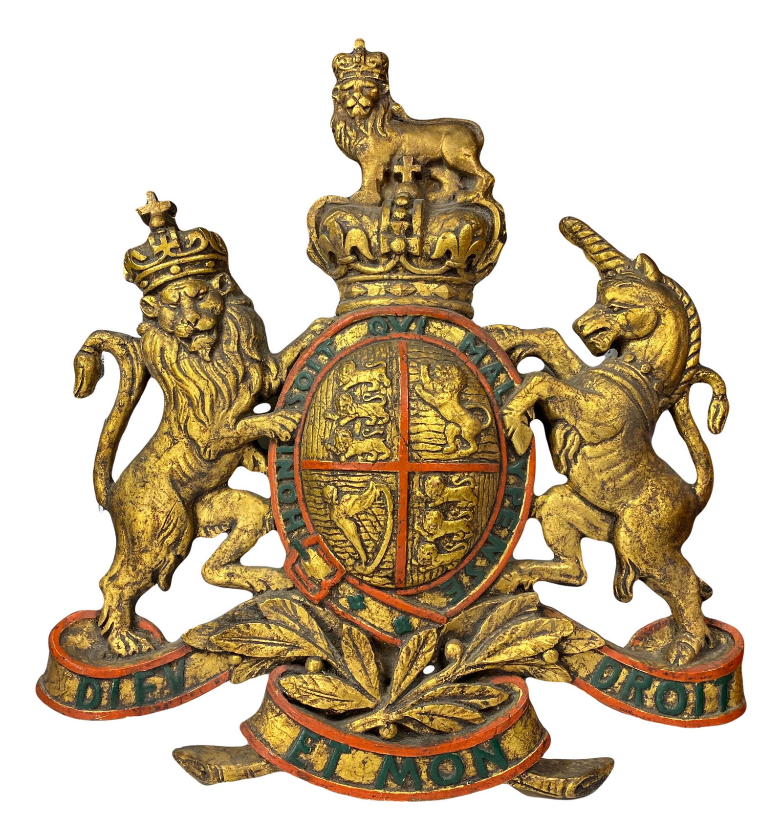 Gold Gilt Ceramic British Coat of Arms Sculpture: handcrafted gilt gilt ceramic wall mount sculpture featuring the United Kingdom and Northern Ireland official coat of arms. Depicts the lion, unicorn and the shield with text on the banner. Signed as 