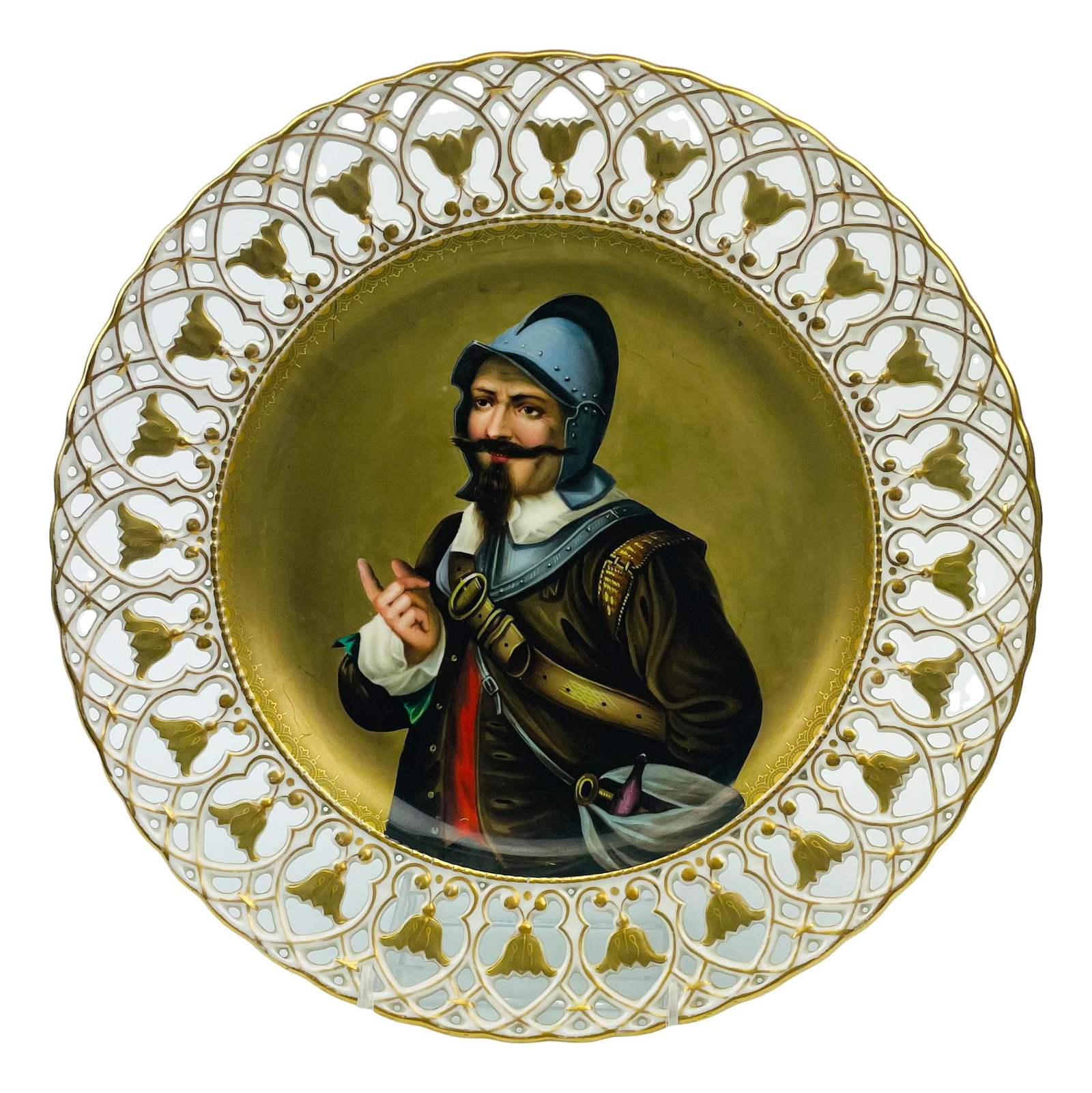 Reticulated Painted Porcelain Conquistador Charger: 20th century European origin porcelain wall mount charger plate. Graced with a hand painted image of a Spanish / Portuguese Conquistador against a dull gold ground. The reticulated scalloped border wi