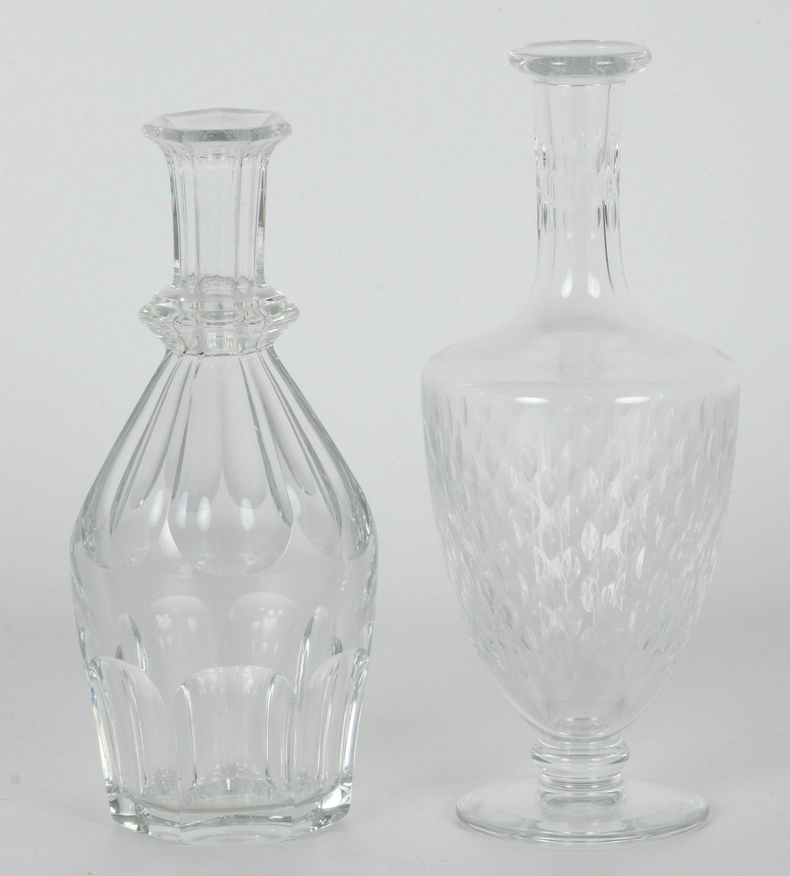 Baccarat Crystal Harcourt & Paris Mini Decanters: 20th century Baccarat studio hand blown French crystal art glass bar barware mini decanters. One modeled in the "Harcourt" pattern, the other in the "Paris" pattern. Measure from 7" - 7 3/4". Signed ~