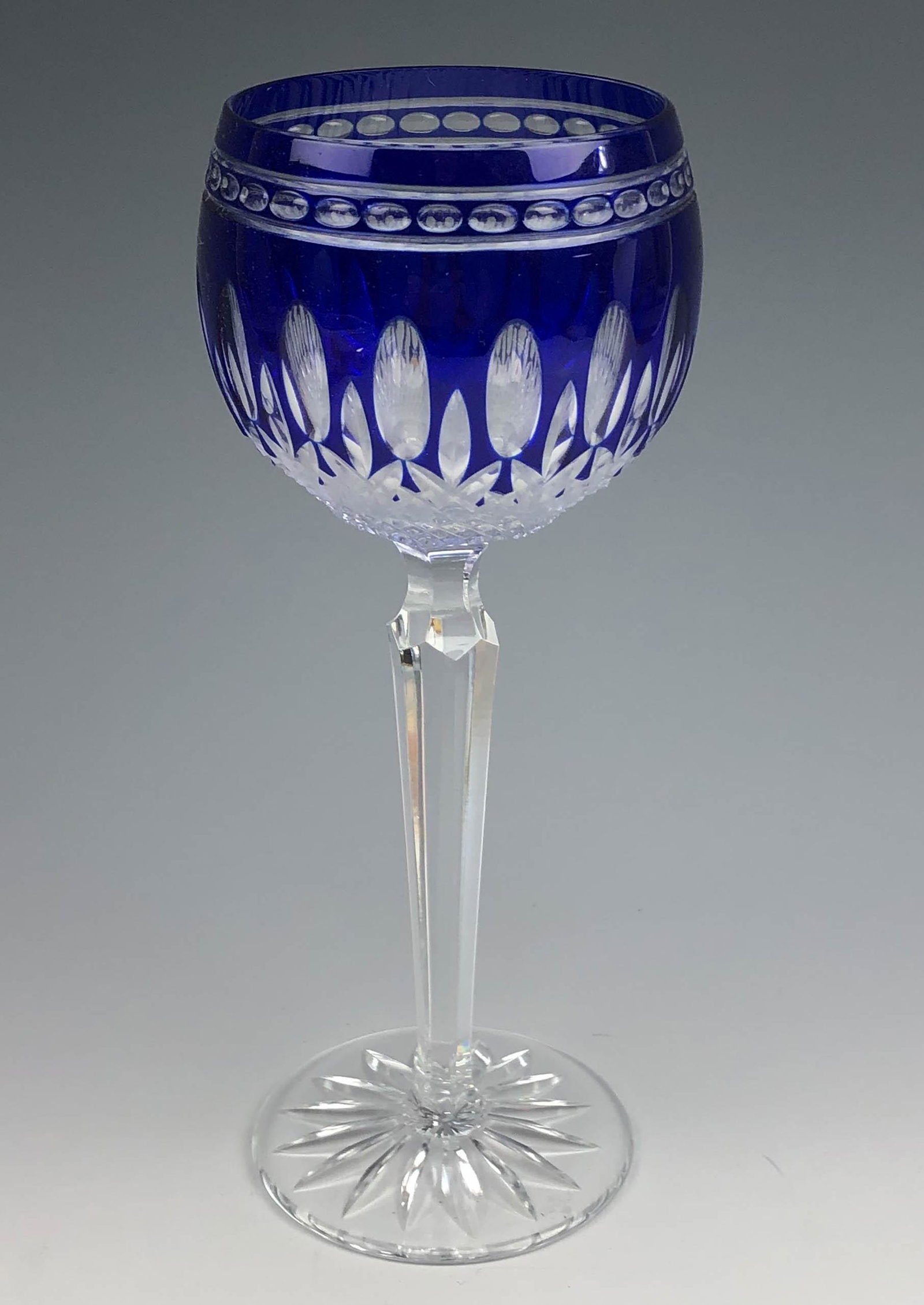 Waterford Crystal Clarendon Cobalt Hock Wine Glass: Waterford (Irish) Cobalt blue cut to clear crystal wine goblet. Clarendon design. Signed on base. Dimensions: 8 X 3 X 3 in. Condition: Good overall condition having mild surface wear. Estate fres