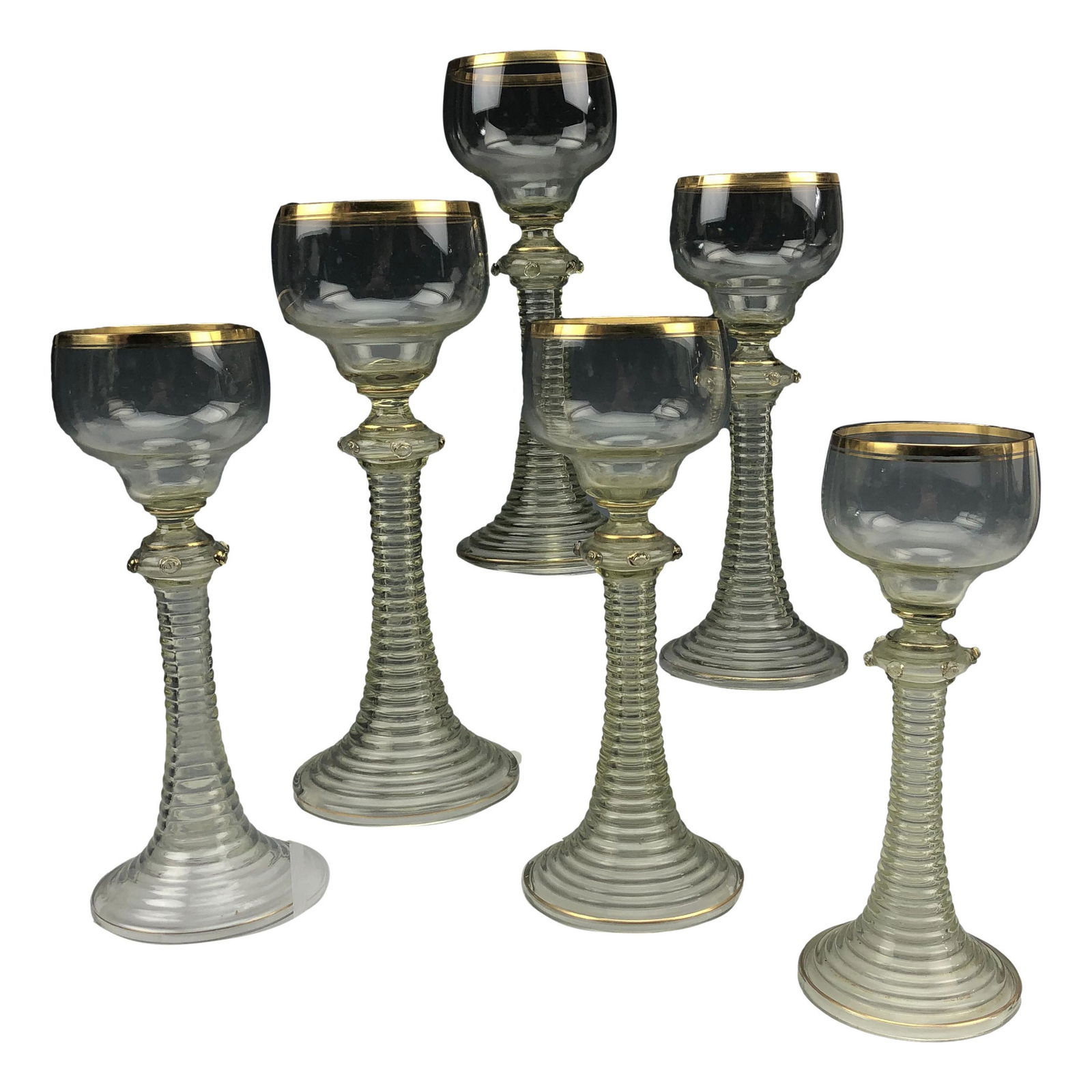 Roemer German 6pc Green Ribbed Wine Glasses: Collection of six vintage German Roemer style wine glasses. Features a green coiled stem and a clear top with a gold gilt rim. Measures approximately 8 in x 3 in x 3 in. Dimensions: 8 X 3 X 3 in. Cond