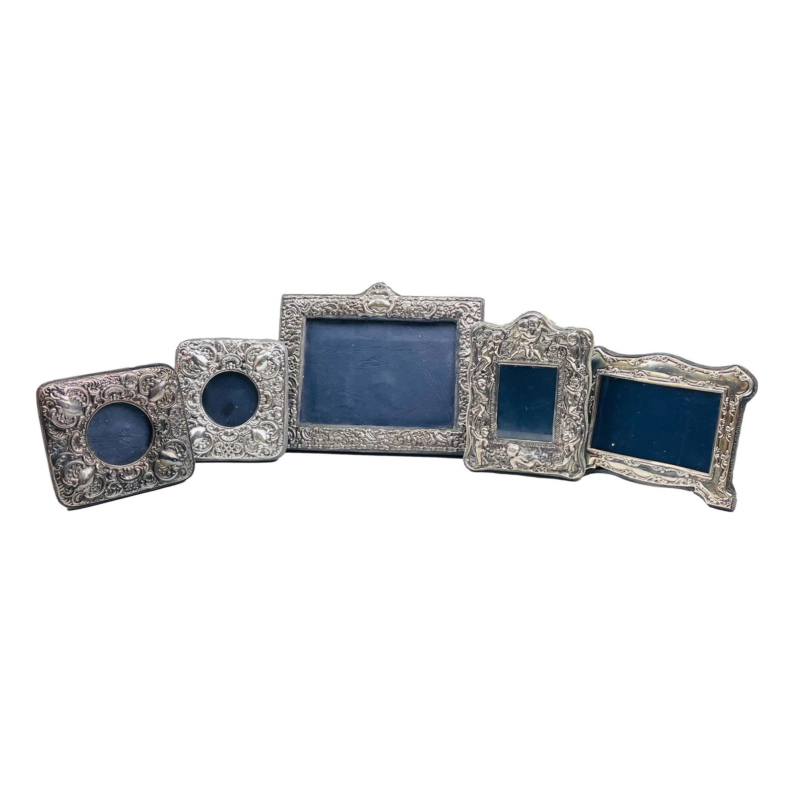 English Sterling Silver Repousse Picture Frame LOT: Includes 5 x English sterling silver photo photograph picture frames. 3 feature raised relief repousse floral decorations, 1 with raised nude mythological cherub angels and 1 with raised scrolls. All