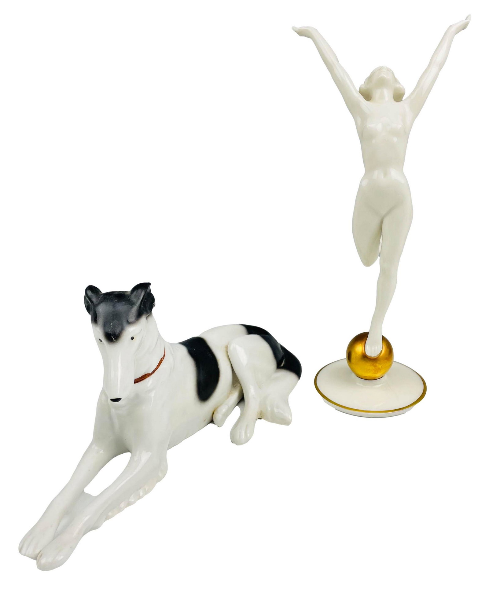 Hutschenreuther Nude Lady & Dog Porcelain Figurine: Two vintage German Hutchenereuther porcelain figurines. Lot includes (1) Lorenz Hutschenreuther Art Deco standing nude on gold ball porcelain figurine, and (1) stamped Germany black and white Borzoi K