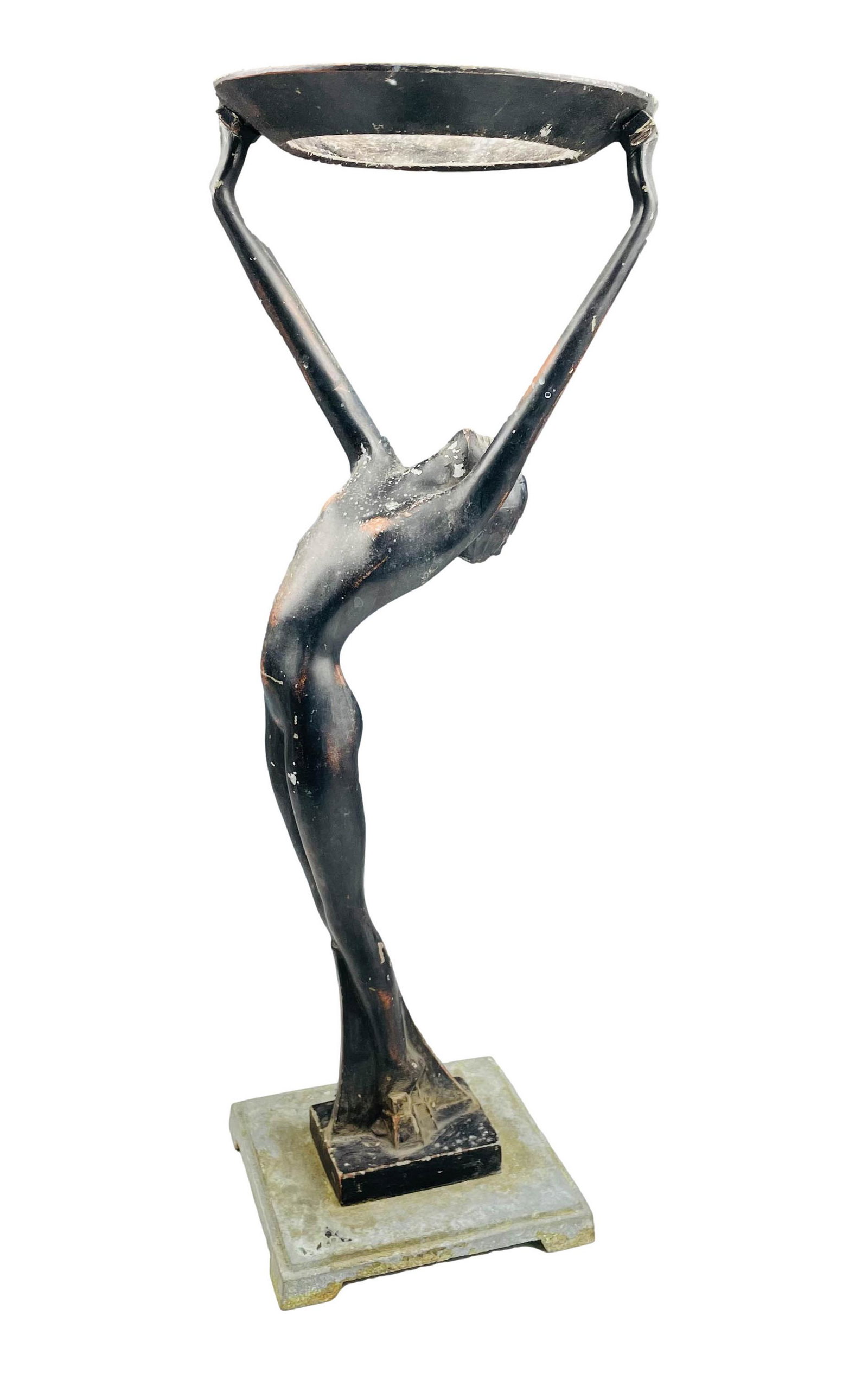 Art Deco Nude Figural Spelter Floor Ashtray Stand: Early 20th century white metal / spelter ashtray stand. Depicts a tall female nude female with raised arms supporting a circular form ashtray. Mounted atop a footed stepped square base. No apparent ma