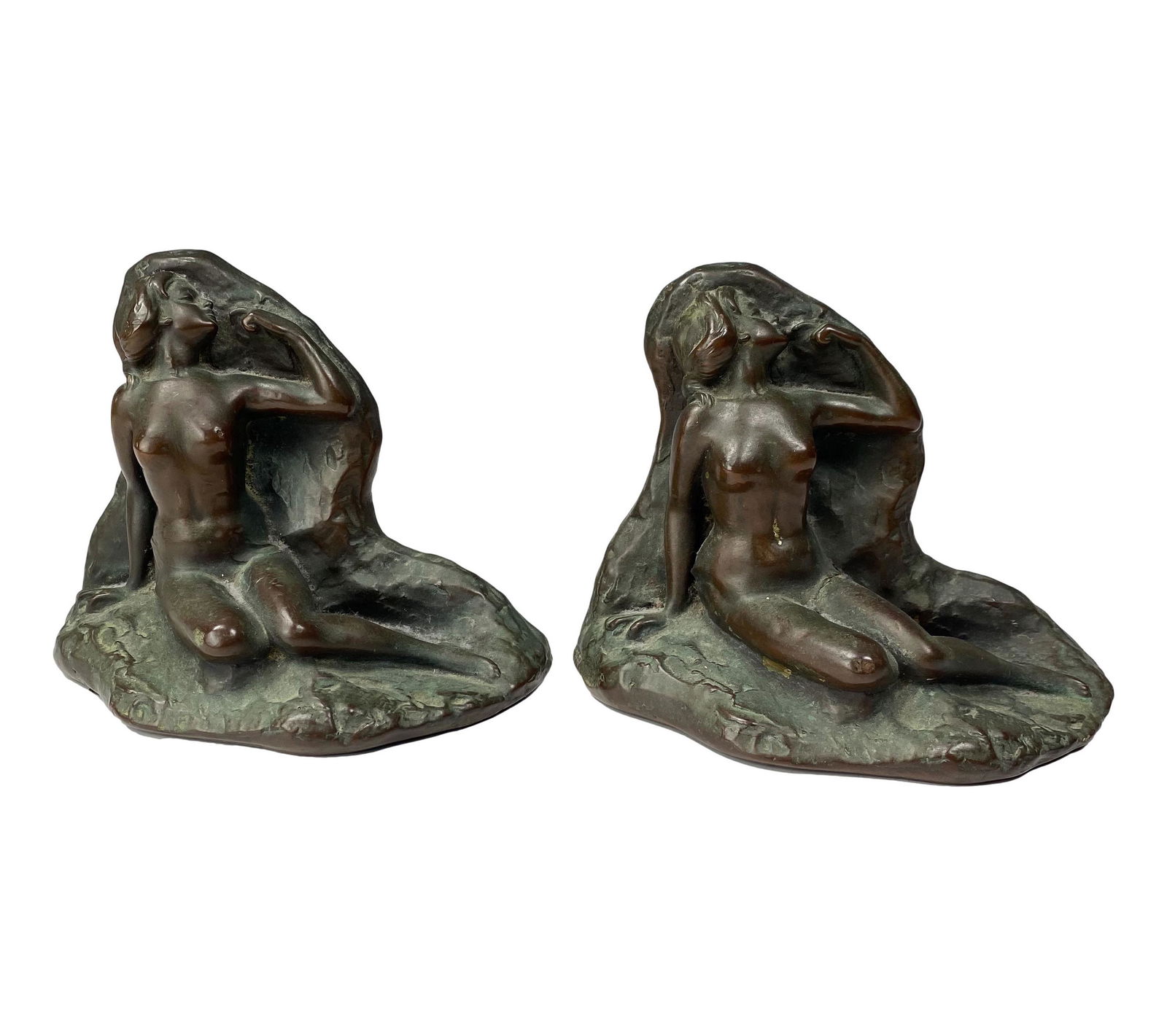 Art Deco Bronze Type Female Nude Art Bookends: Pair of figural Art Deco nude female bookends. Crafted of bronze over composition. No apparent signature. Dimensions: 5.5 X 7 X 4 in. Condition: Good overall condition with minor wear. Estate Fre