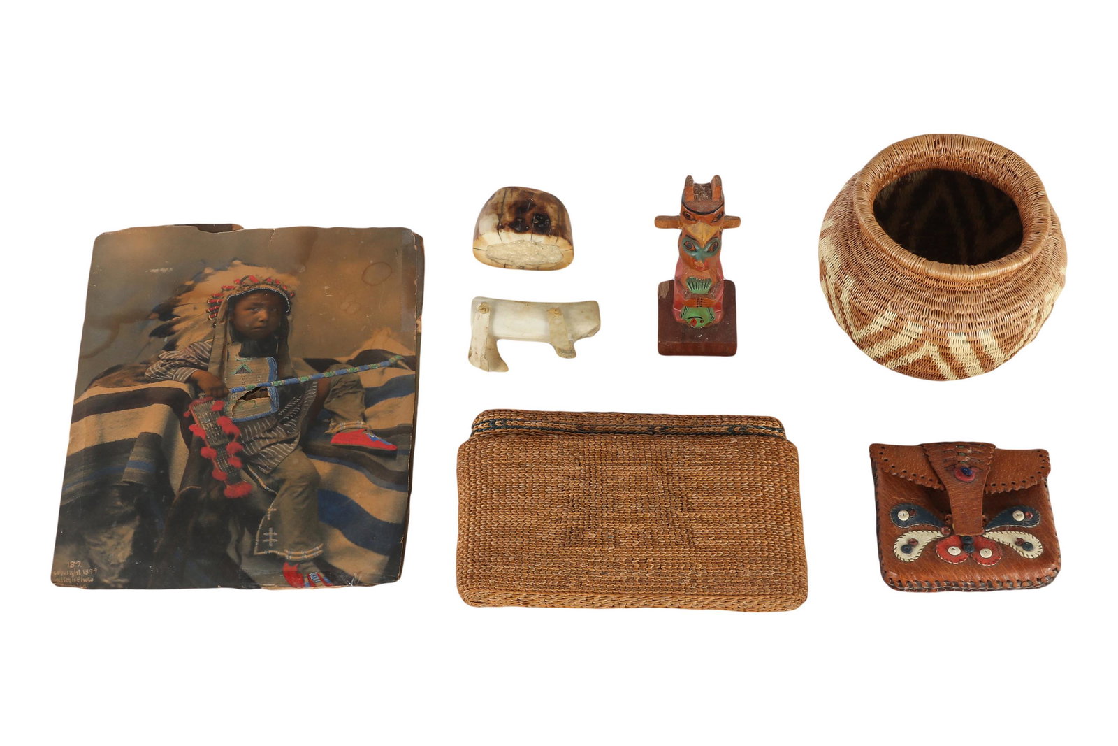 Native American Indian Vase Figurine Purse 7pc LOT: Estate collection lot of Native American Indian artifacts. Lot include: (1) hand woven vase, (1) figural wood carved totem pole sculpture, (1) stitched leather pure, (1) woven interlocking purse, (1) 