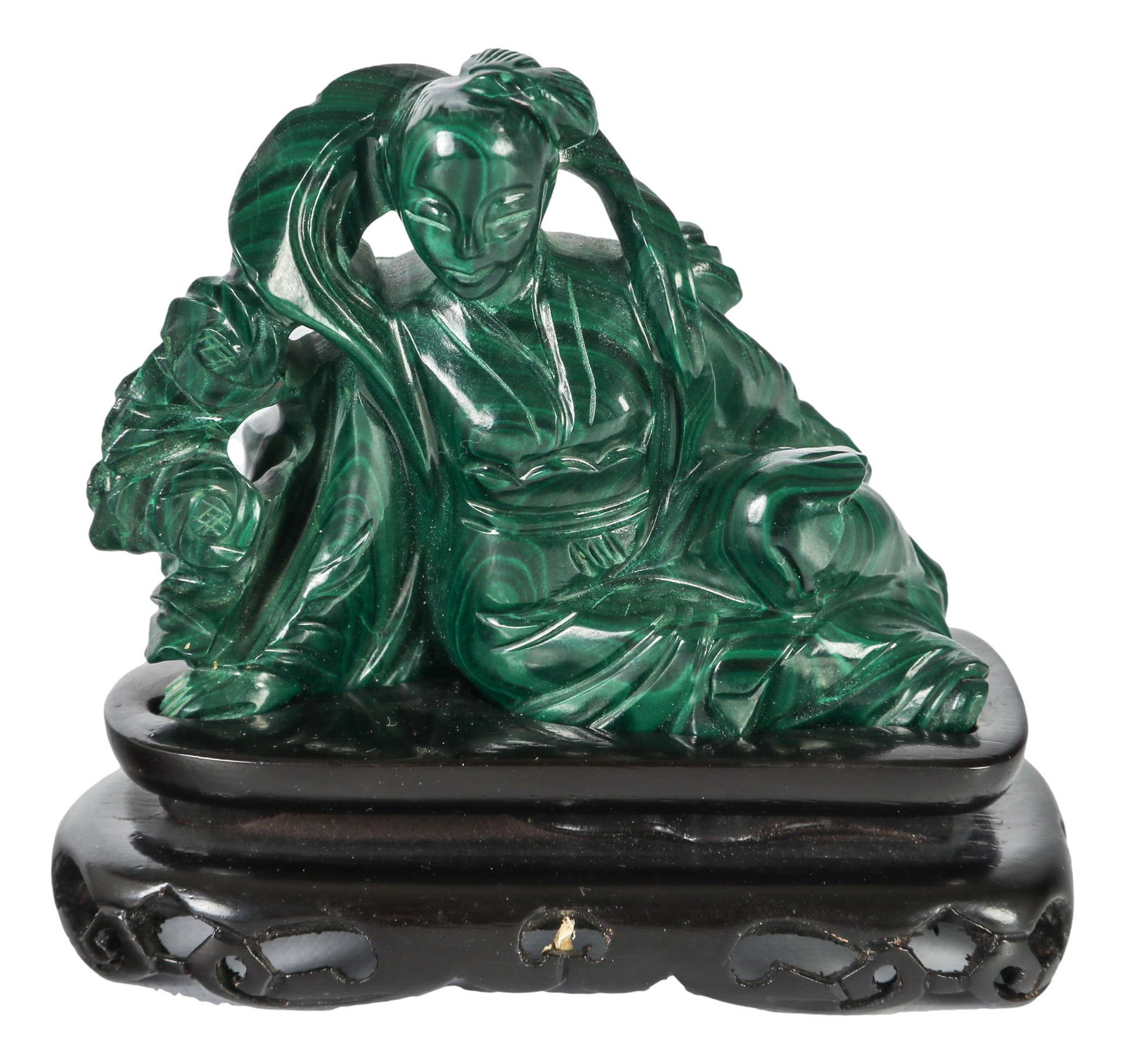 Chinese Export Green Malachite Kwan Yin Sculpture: 20th century hand carved green malachite hardstone sculpture of Chinese cultural art. Features the revered Buddha Kwan Yin deity in seated pose. Designed to rest on a dark colored carved and pierced w