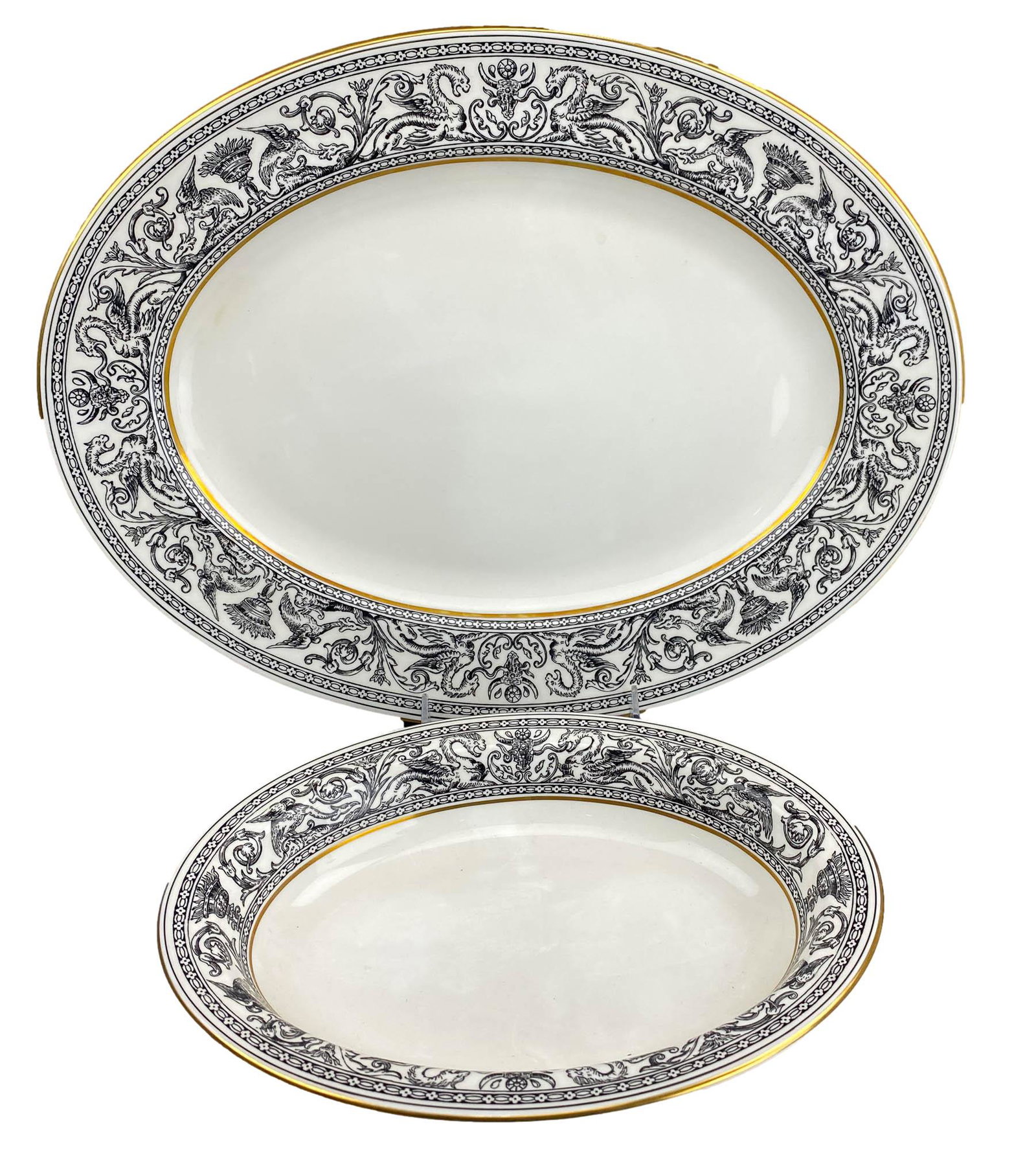 Wedgwood Florentine Black Oval Platter & Bowl LOT: Wedgwood English bone china "Florentine Black" dinnerware. Production years : 1959 - 1997. Design showcases a dragon and floral motif in black, against a white ground. Gold trimmed borders. Includes 1
