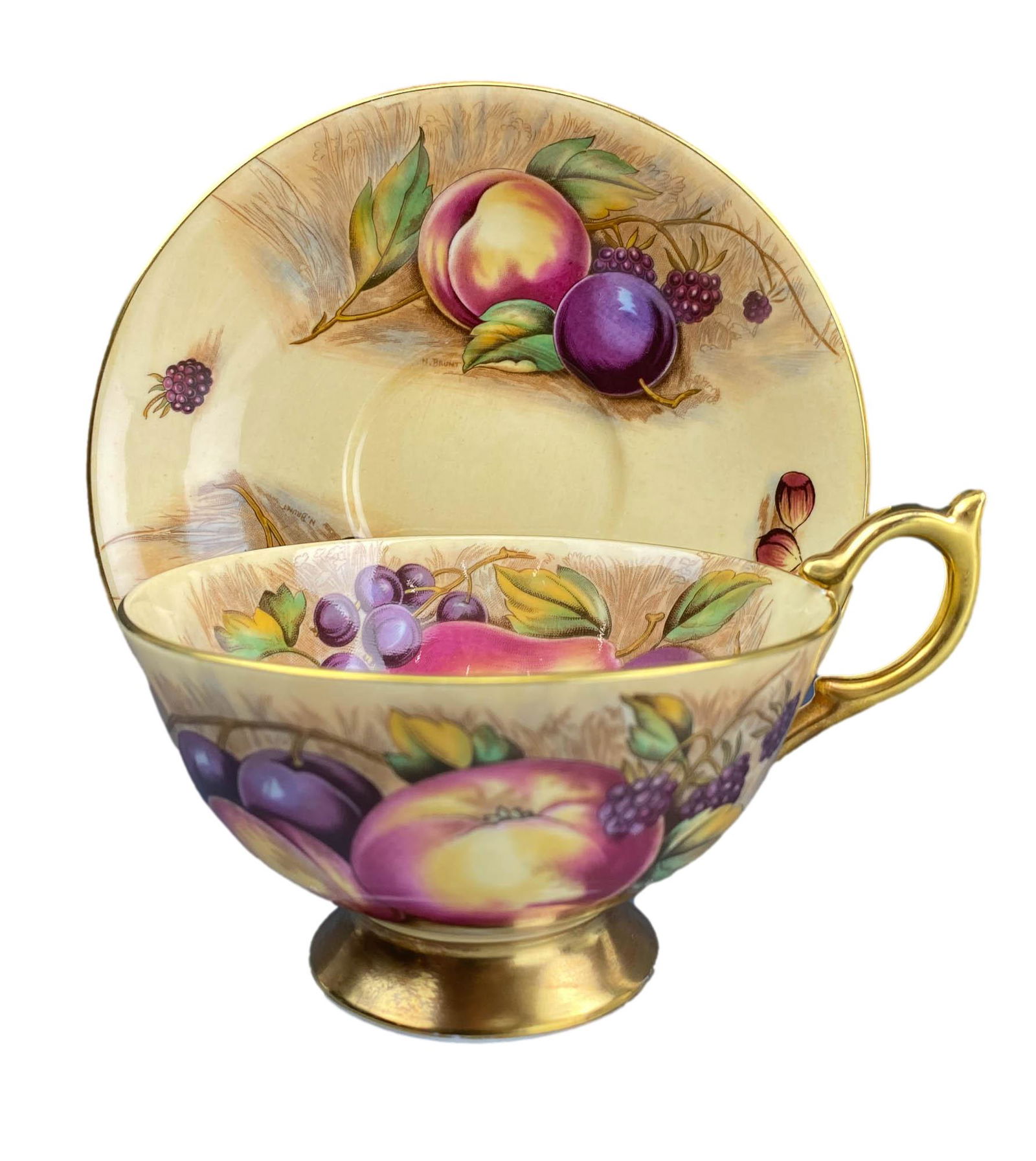 Aynsley Orchard Gold signed Brunt Tea Cup & Saucer: 20th century English fine bone china curio cabinet teacup and matching saucer display set. Pattern : Orchard Gold. Features a harvest scene of luscious ripened fruits, berry and nuts. Gold embellished