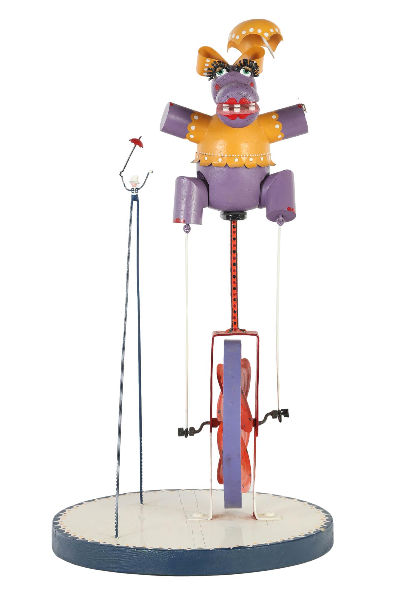 Folk Art Metal Wood Whimsical Whirligig Sculpture: Mechanical studio handcrafted carved painted wood and metal whimsical sculpture. Features a long eyelash purple hippo with umbrella and large bow propped atop a hand wind spin wheel. A metal figure ho