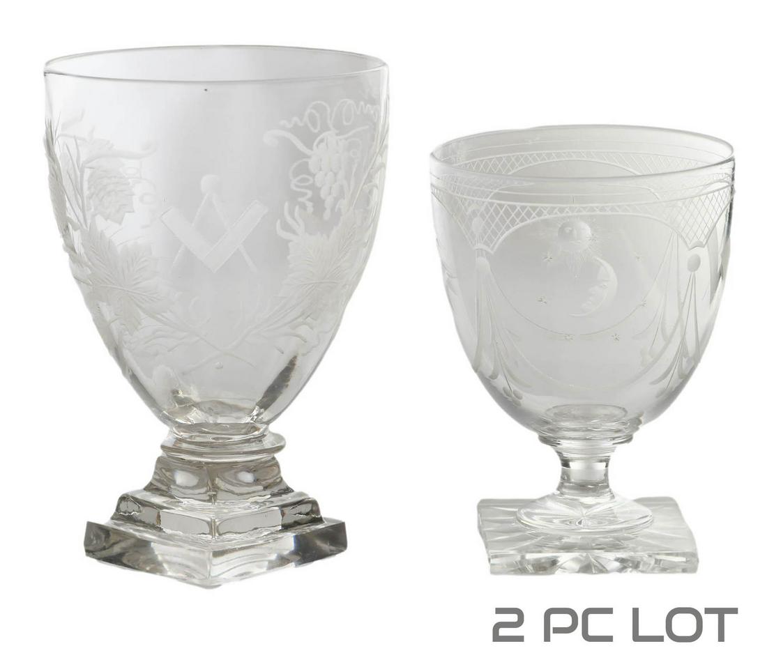 Antique Masonic Engraved Crystal Goblet Vase 2pc: Two 19th Century crystal Masonic Freemasons wine glasses. Lot include (1) 4.75" x 3.5" glass, with intricate sun, moon, eye and the Masonic compass engraved motif, and (1) 5.75" 5" glass with floral a