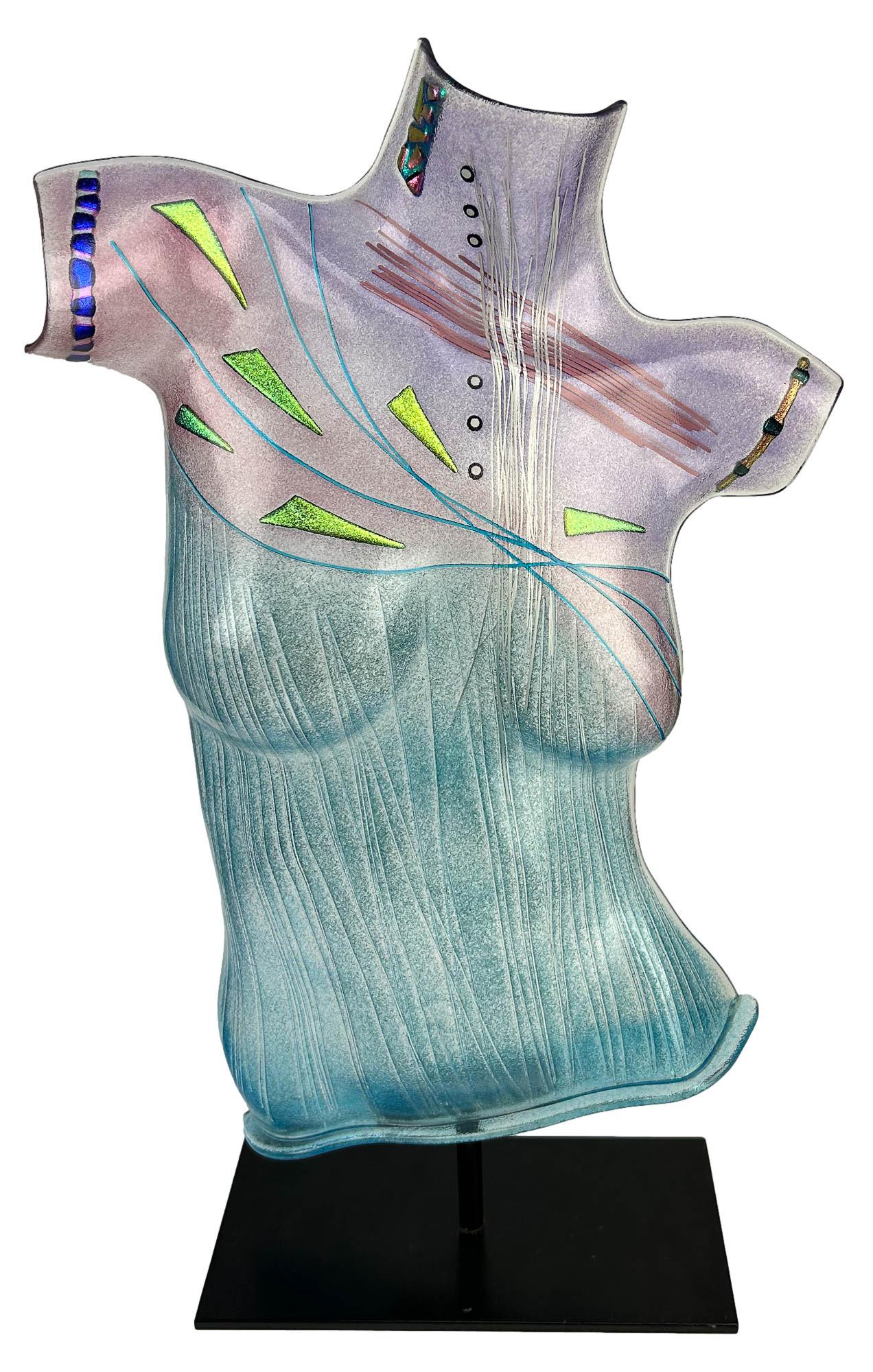 Robert Buick Nude Female Torso Art Glass Sculpture: Robert Buick contemporary fused art glass nude sculpture. Features a woman's nude body torso made from fused kin fired colorful applied glass pieces mounted on a rectangular steel black base. Signed R