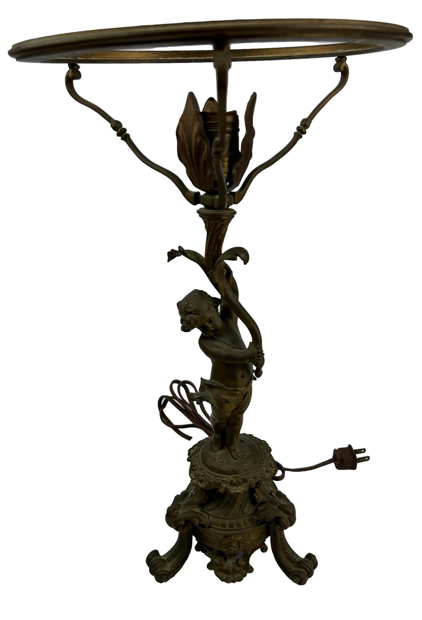 Antique Bronze Art Nouveau Nude Cherub Table Lamp: Late 19th early 20th century bronze library desk table lamp fixture. Depicts the mythological heavenly angels in standing pose supporting a stem like form that forms the rim where a glass lamp shade w
