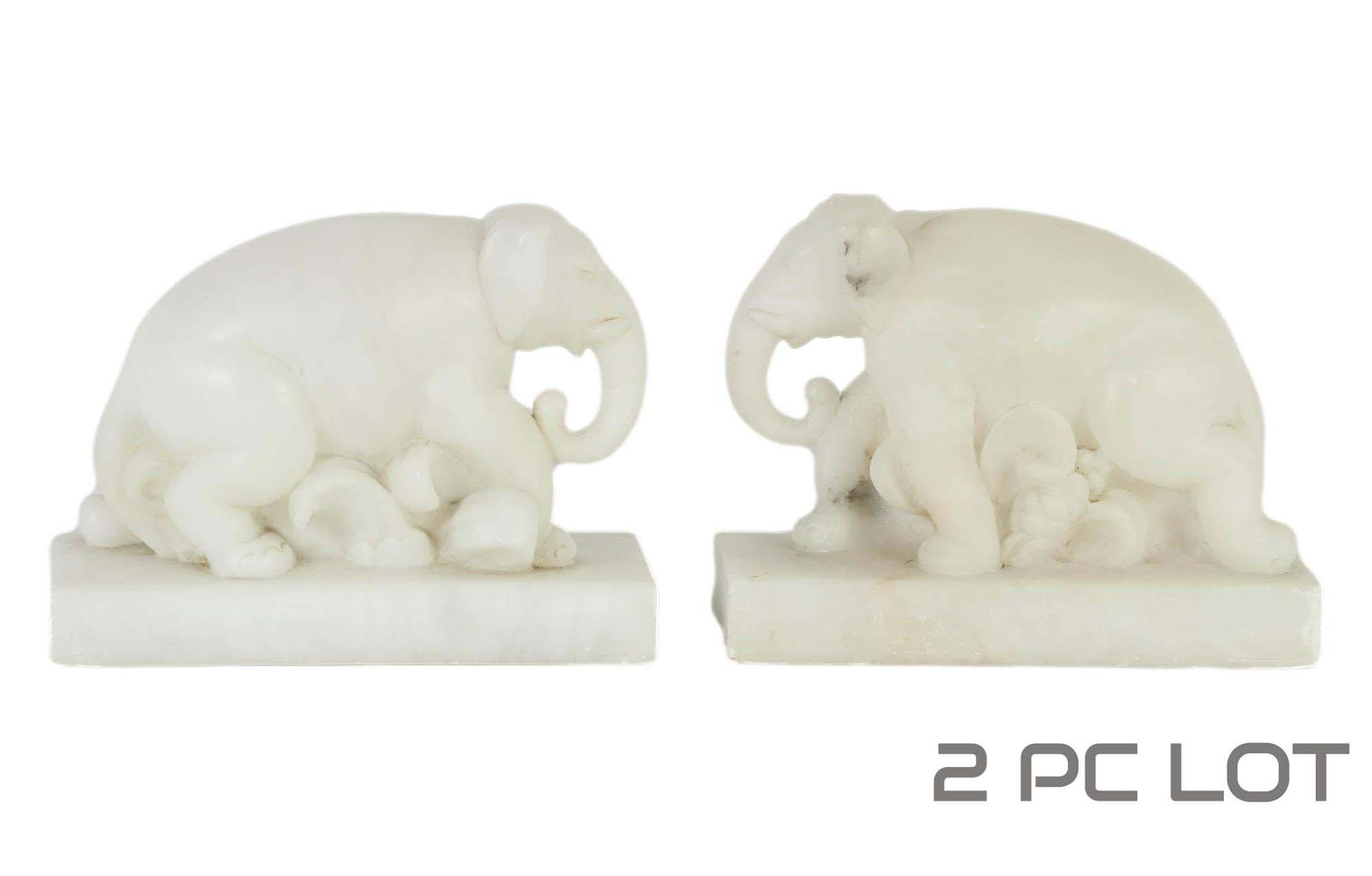 White Alabaster Elephant Bookend Sculpture 2pc LOT: 20th century hand carved alabaster mineral rock sculptures / library desk bookends. Each modeled as an elephant atop a rectangular base. No apparent markings. Dimensions: 7 X 8 X 3.75 in. Condition: