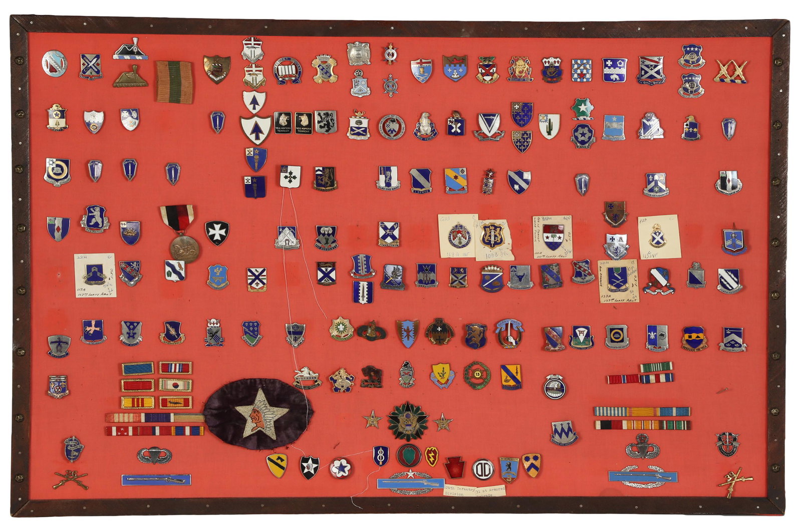 US Military Pin Medal Ribbon Collection & ID Books: An estate collection of 120+ World War II era to late 20th Century United States Military service pins. Various services, units, and styles, mostly chevron or shield designs. Accompanied by: 21 Second