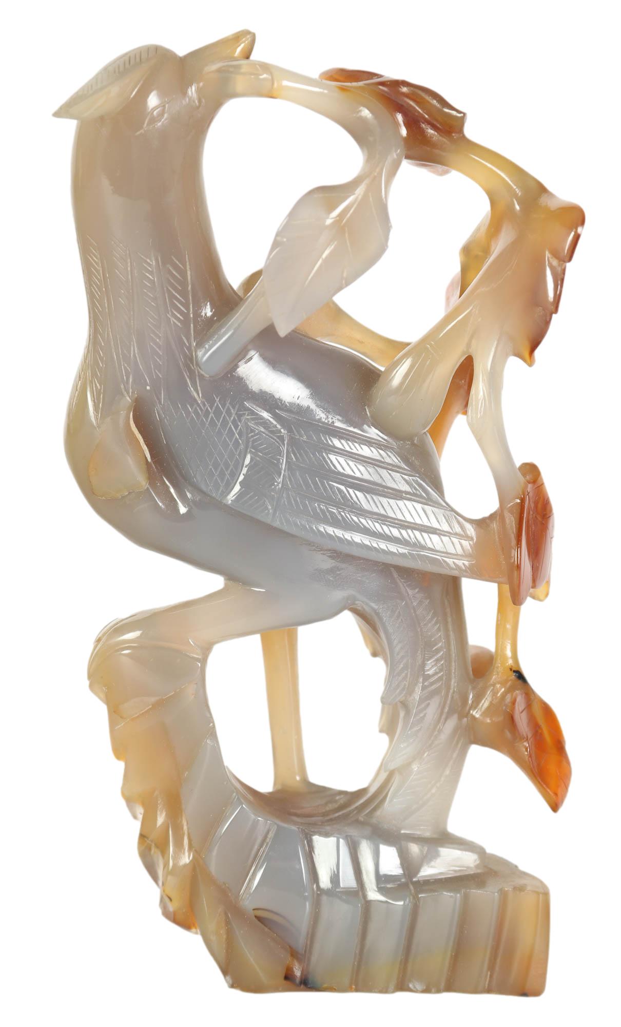 Chinese Carved Agate Stone Foliate Bird Sculpture: Chinese carved bird figurine. Crafted from an opaque grey and red brown agate hand stone. Depicting a bird perched on a leafy vine. No apparent makers mark.Dimensions: 6.25 X 3.5 X 2 in. Condition: