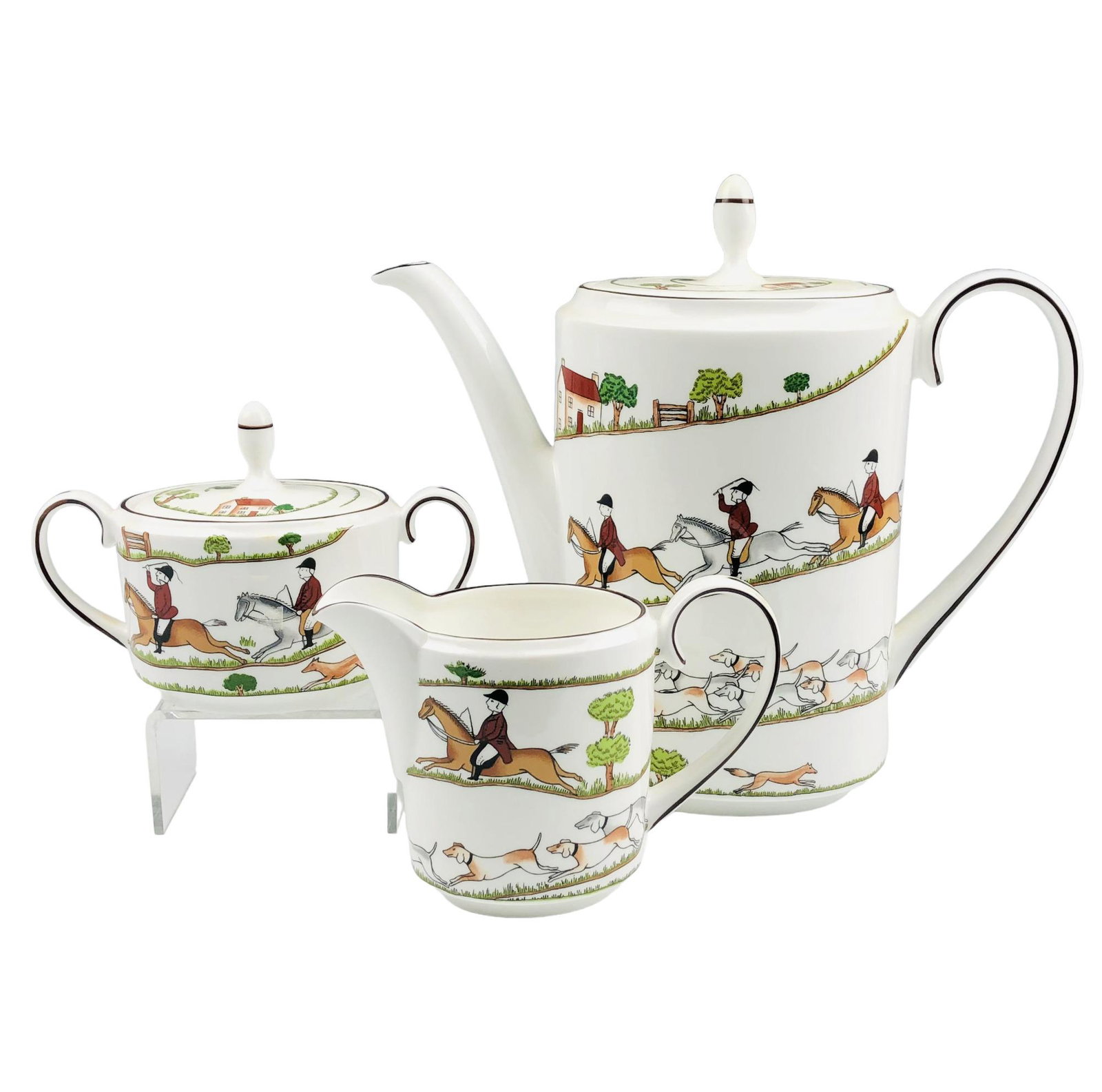 Wedgwood Hunting Scene Coffee Pot Creamer & Sugar: Each of these English bone china dinner articles modeled in the Hunting Scene by Wedgwood. Production years : 1991 - 2010. Feature men on horseback, trees, houses and dogs chasing down a fox. Black tr
