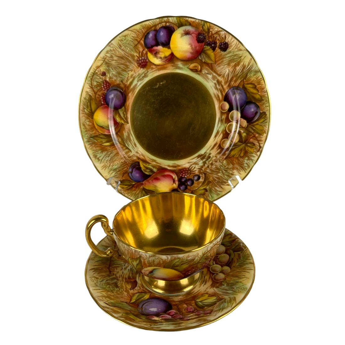 Aynsley Orchard Gold Tea Cup Saucer Plate Trio Set: 3 piece England English bone china by Aynsley. Modeled in their Orchard Gold pattern. Production years : 1989 - 2015. All the three articles, the tea cup, saucer and salad plate feature a harvest scen