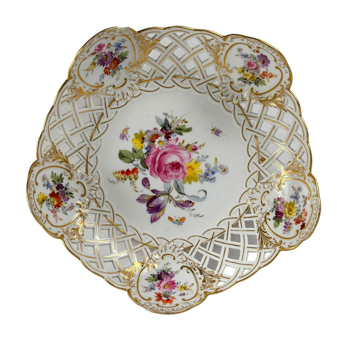Meissen German Porcelain Reticulated Floral Bowl: Antique Meissen Germany German porcelain bowl. Design features hand painted brightly colored spring flowers in the center, with floral arrangement in the 5 cartouches around the border on both sides, 