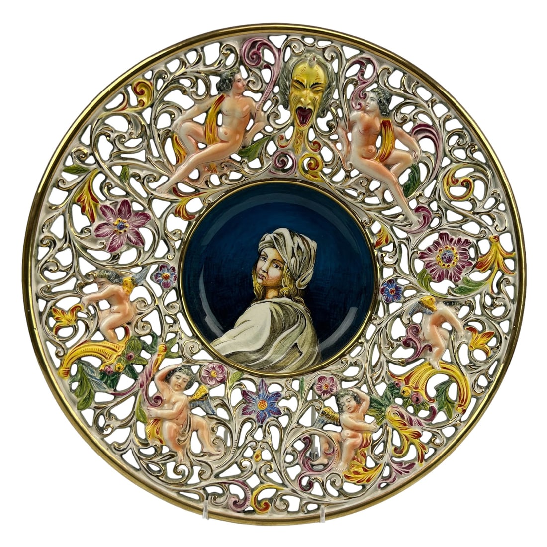 Capodimonte Nude Maiden Cherub Pierced Charger: 20th century Italy Italian hand crafted and painted ceramic pottery wall mount charger. Center features the portrait of a lady wearing a turban, the pierced reticulated border with raised relief desig