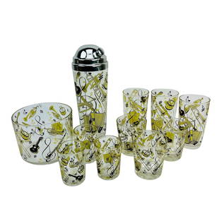 Hazel Atlas Glass Tumbler Shaker Ice Bucket LOT: Estate lot of a total of 11 pieces of American origin glass artistry. All decorated with musical instruments against a clear colorless ground. Includes varying sized glasses, tumblers, a cocktail shak