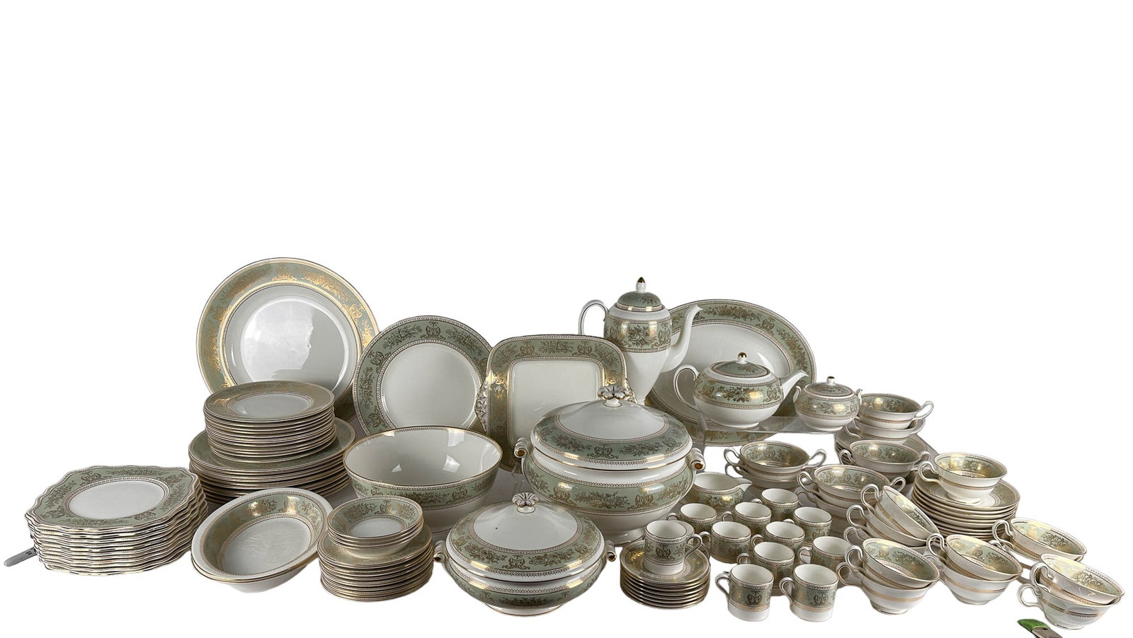 Wedgwood Porcelain 112pc Columbia Sage Green SET: A set of English Wedgwood bone china dinnerware in the sage green and gilt border "Columbia" design. Lot includes: (12) .5" x 10.75 x 10.75 dinner plates, (12) .5" x 8" x 8" salad plates, (12) .5" x 8